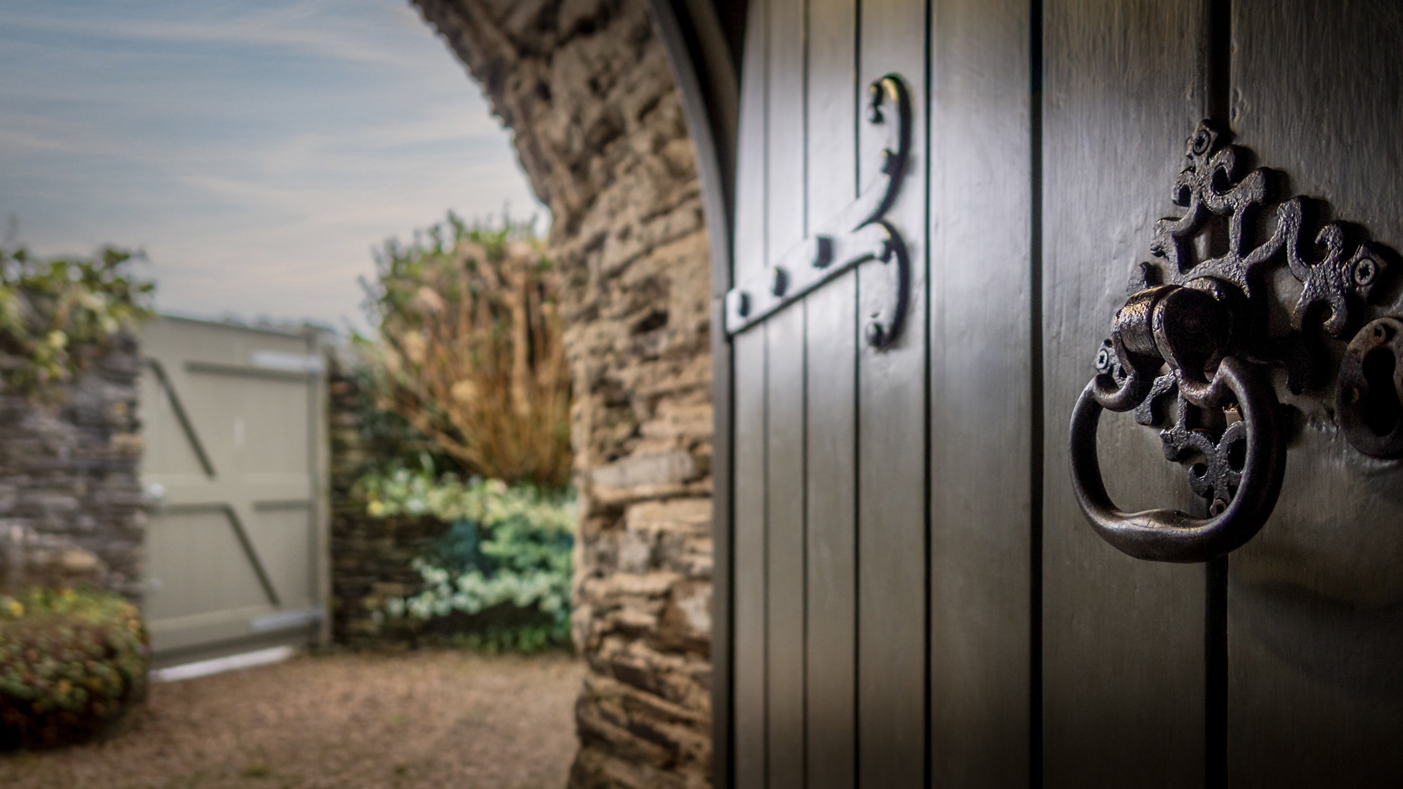 The front door, open to show part of the garden at Trelissick Water Tower, Cornwall