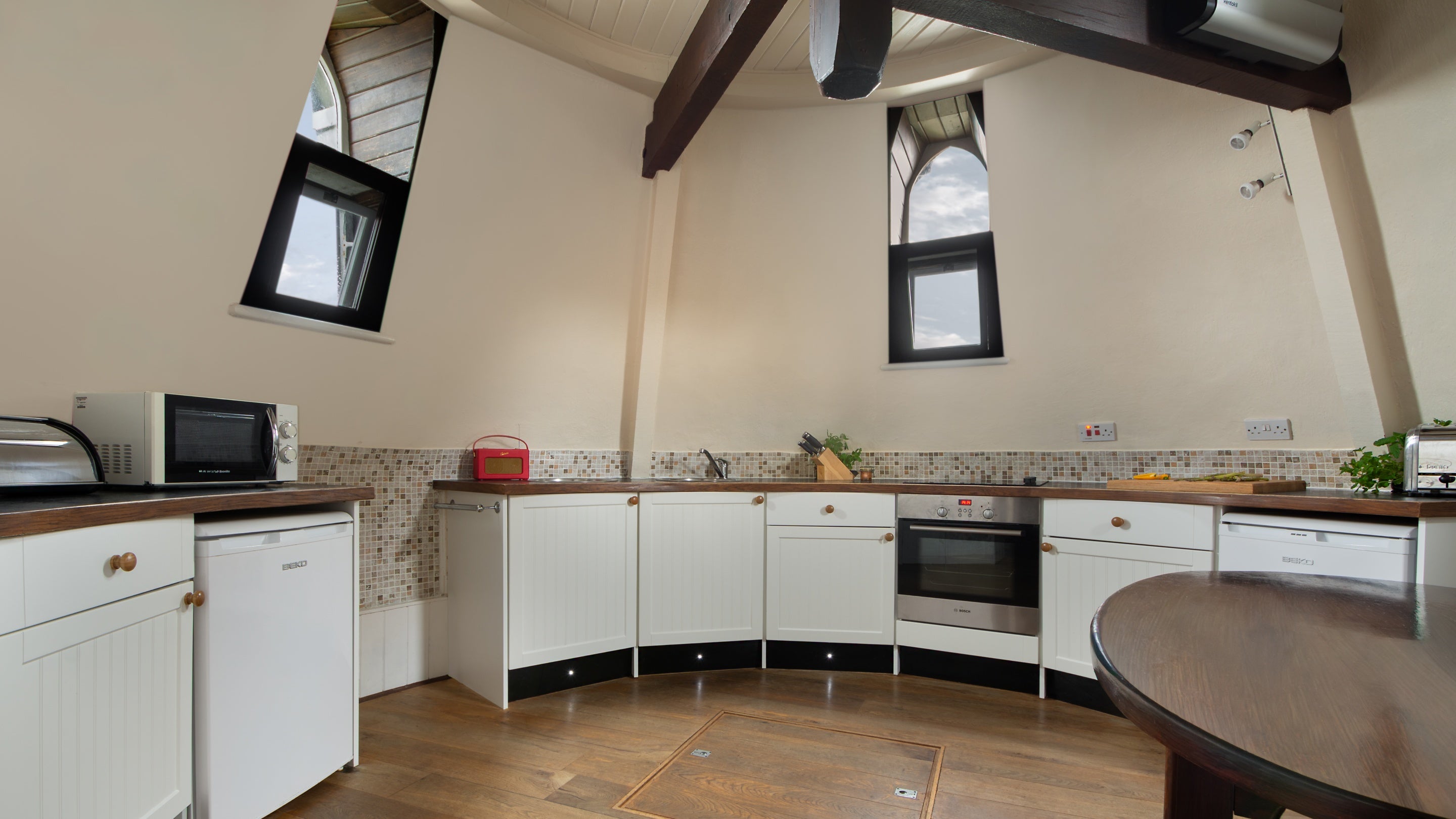 The kitchen-diner, a circular room on the top floor of Trelissick Water Tower, Cornwall