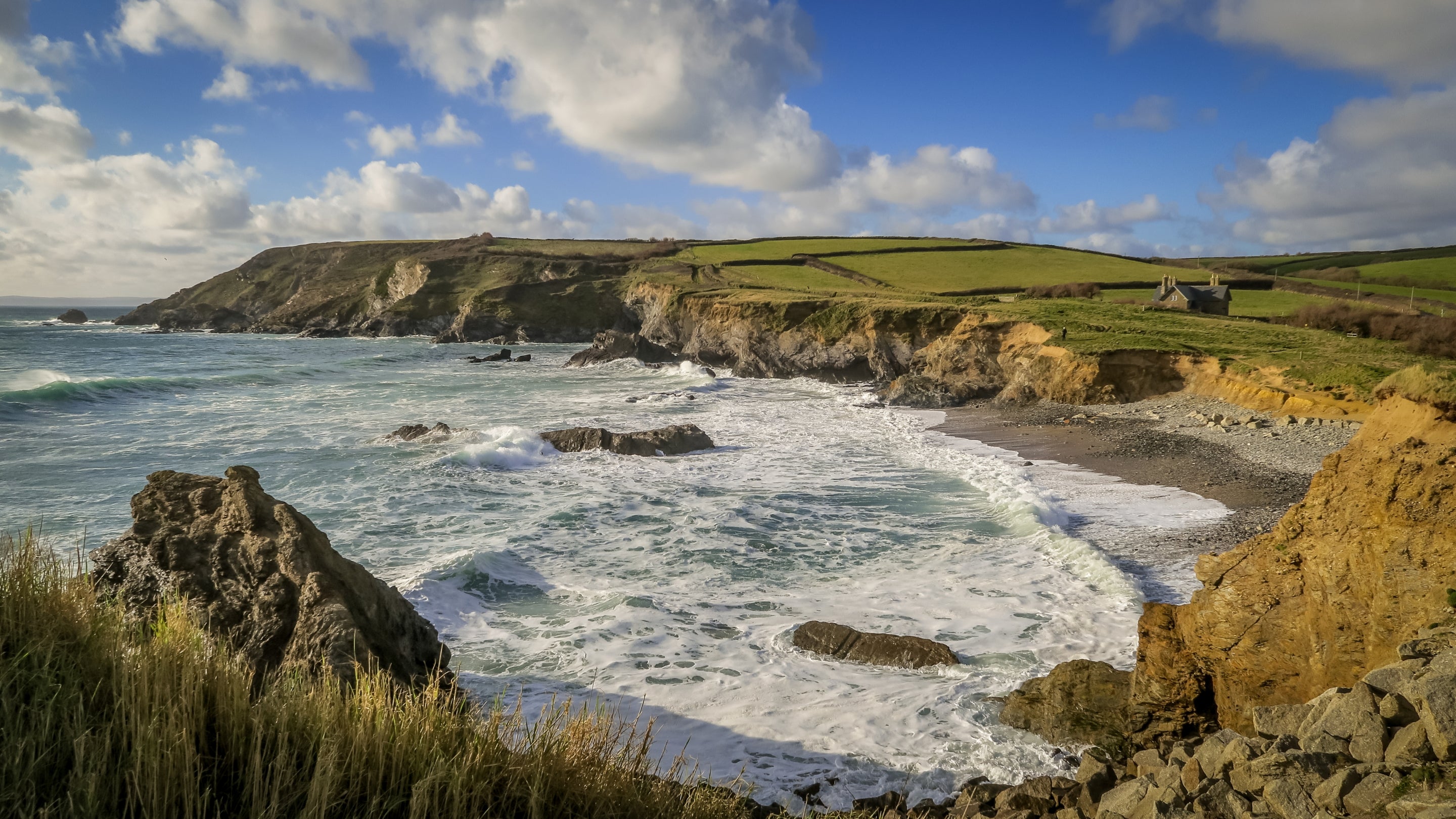 A view of Winnianton Farmhouse from the nearby beach, Cornwall