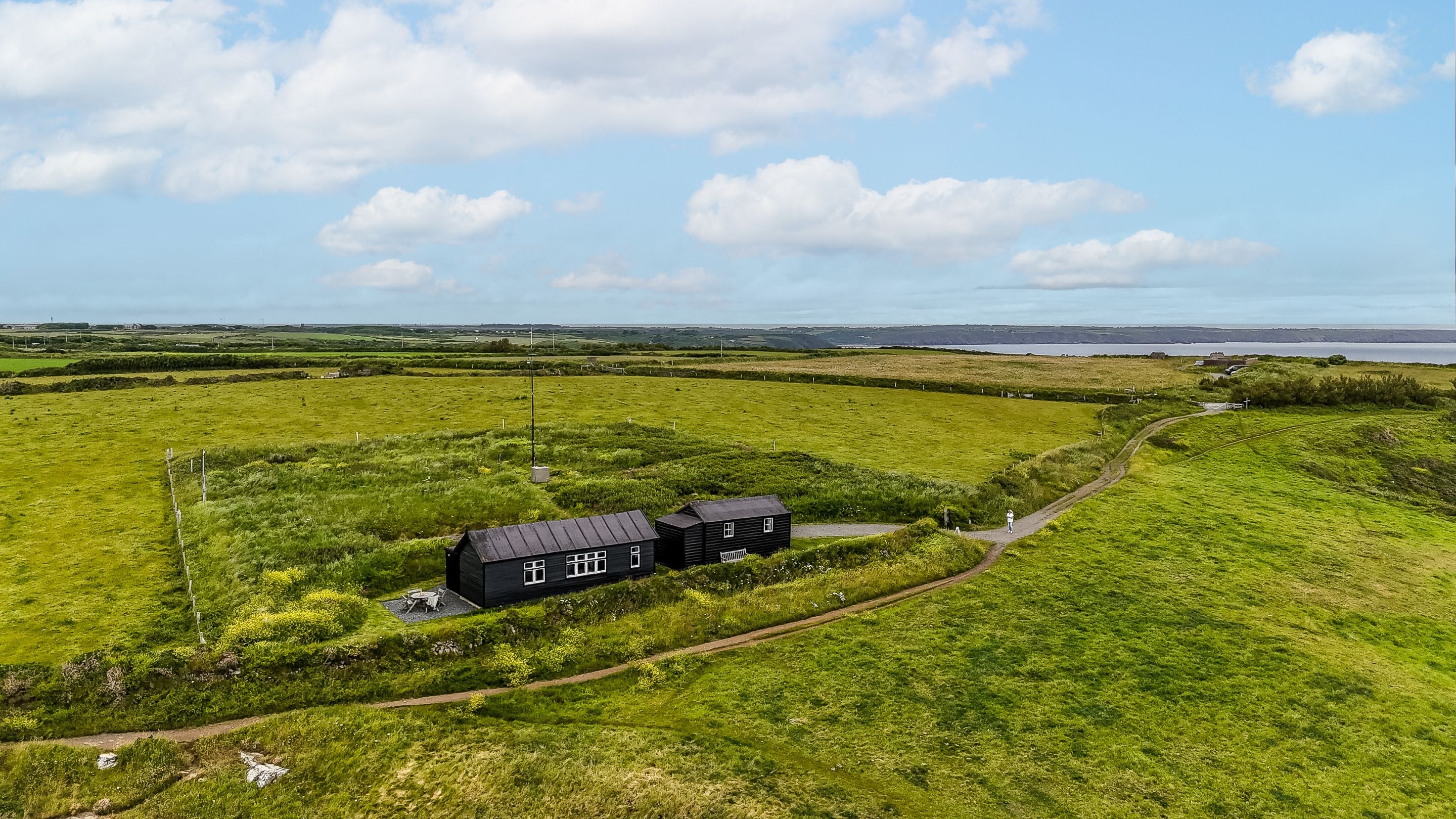 An aerial view of Wireless Cottage and the surrounding coast, Cornwall