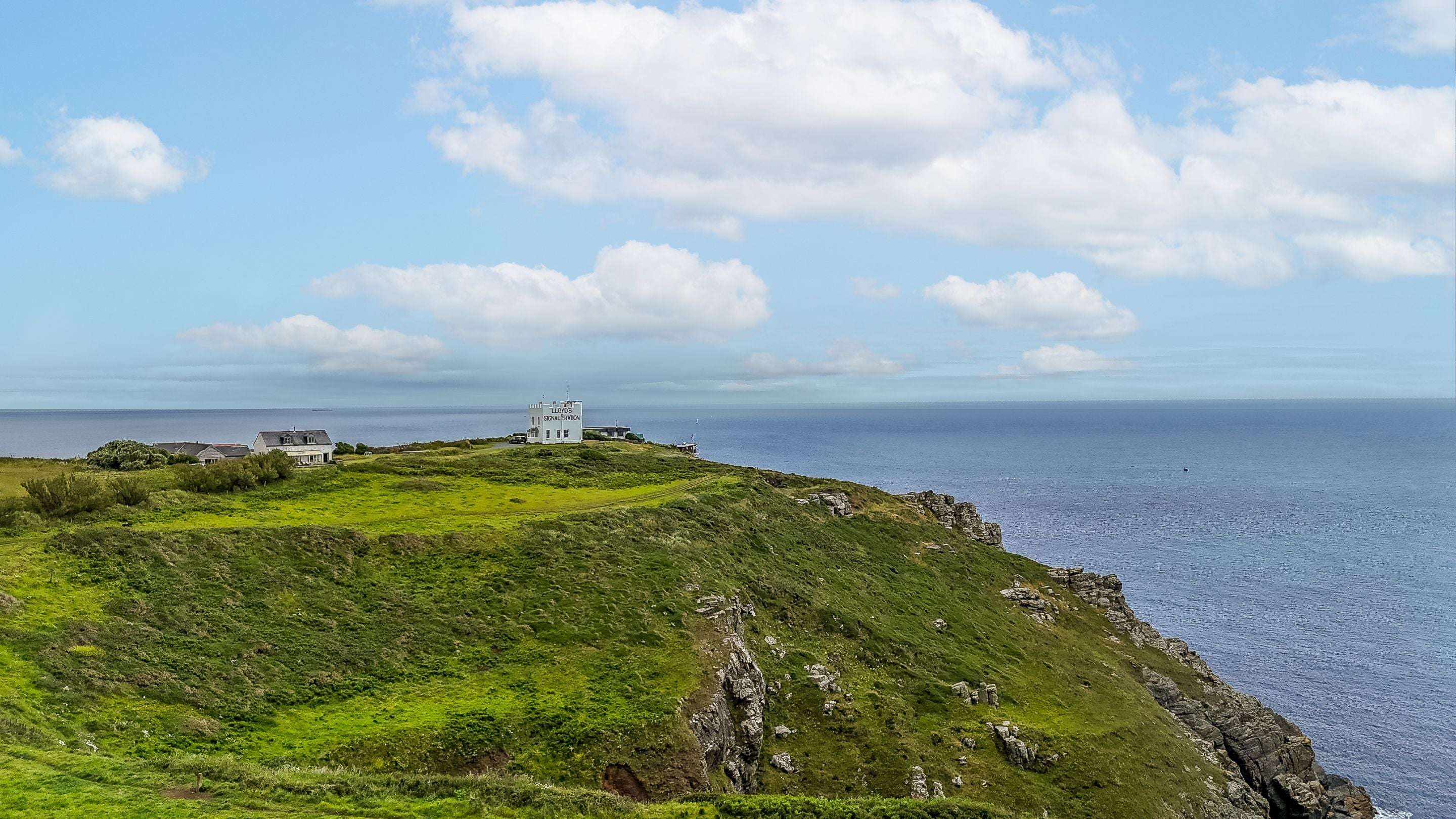Coastal cliffs with whitewashed buildings near Wireless Cottage, Cornwall