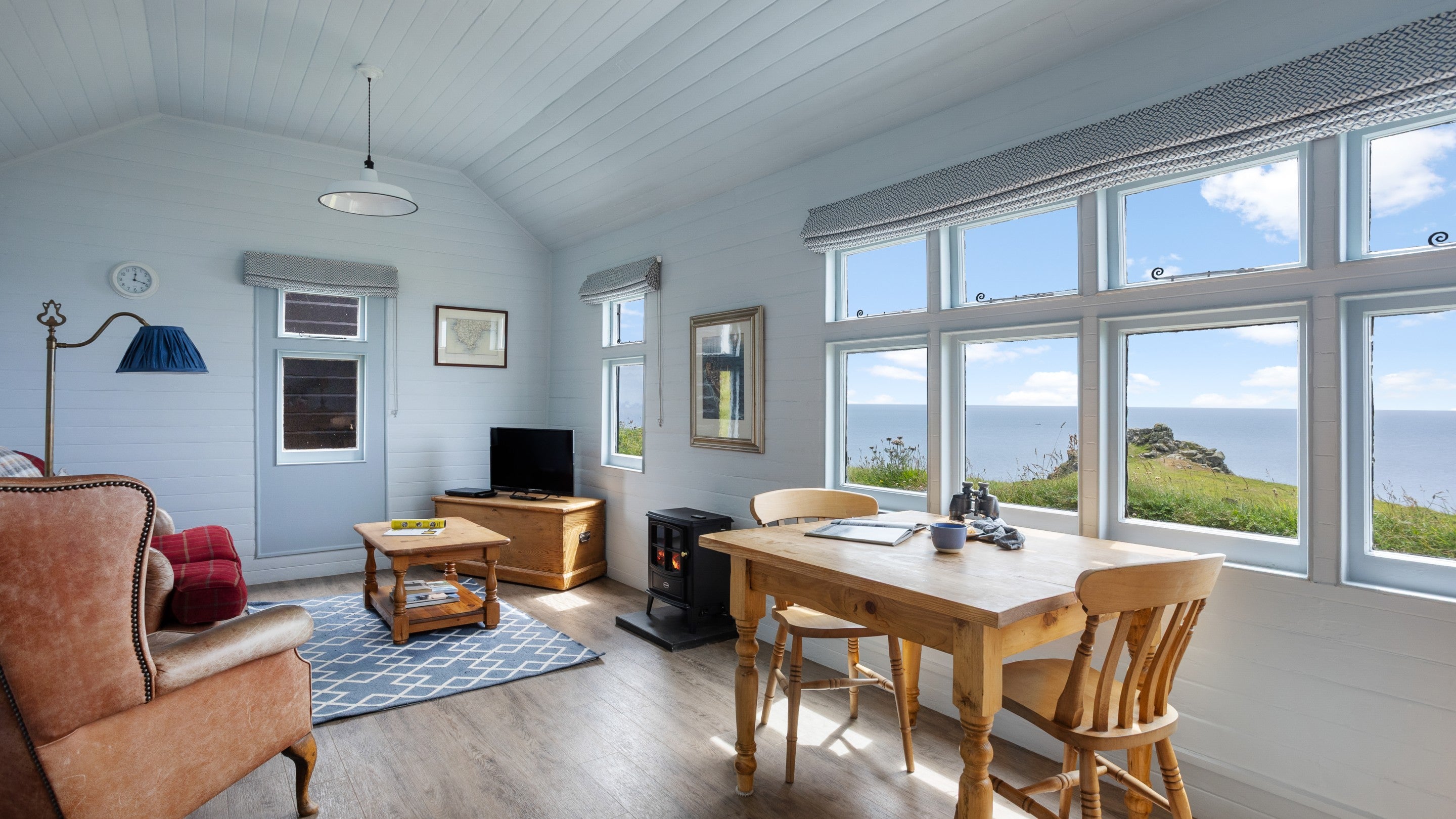 The sitting and dining room with sea view at Wireless Cottage, Cornwall