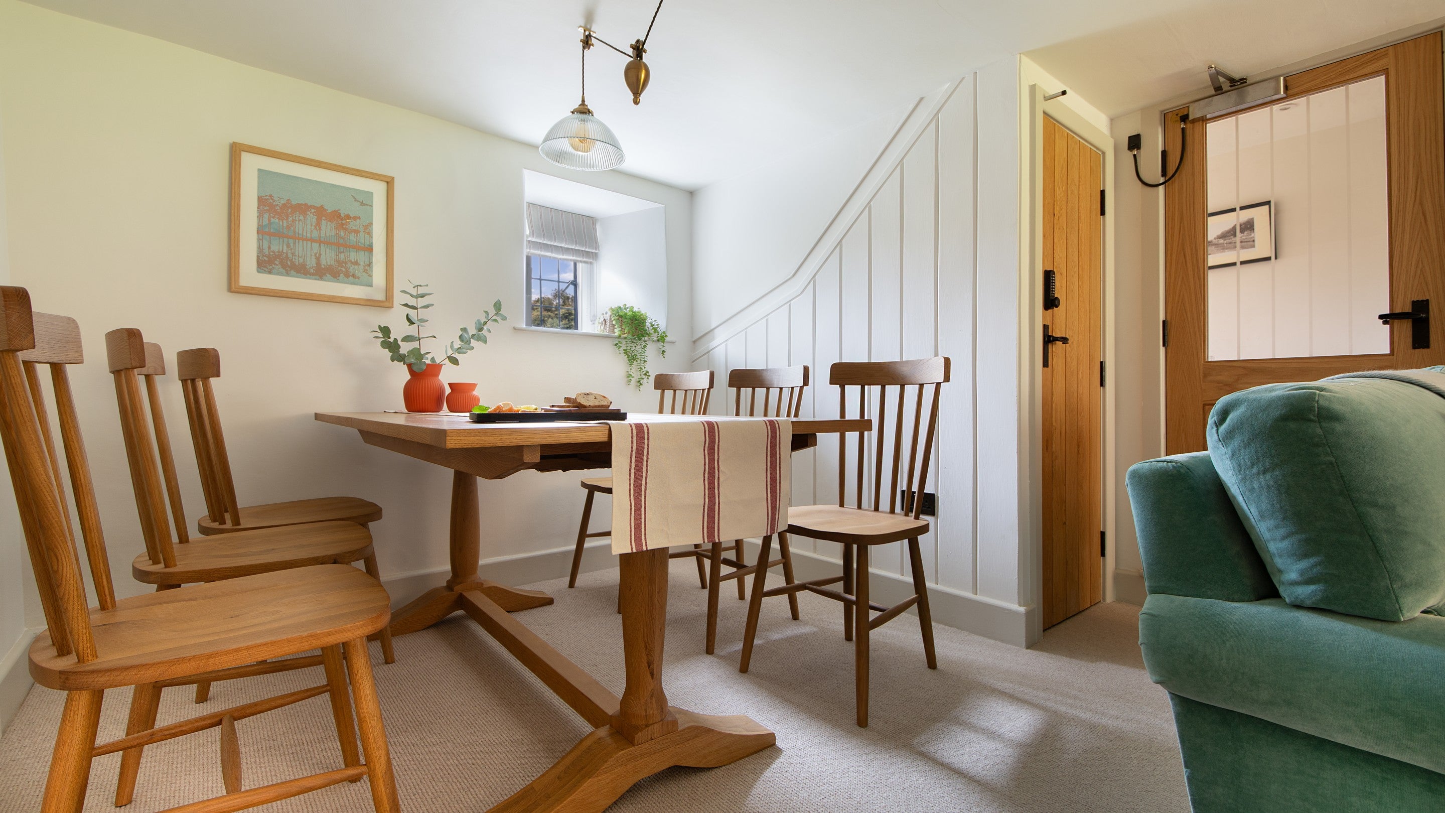 The dining table with chairs for six in the open-plan sitting and dining room at 1 Arlington Row, Gloucestershire