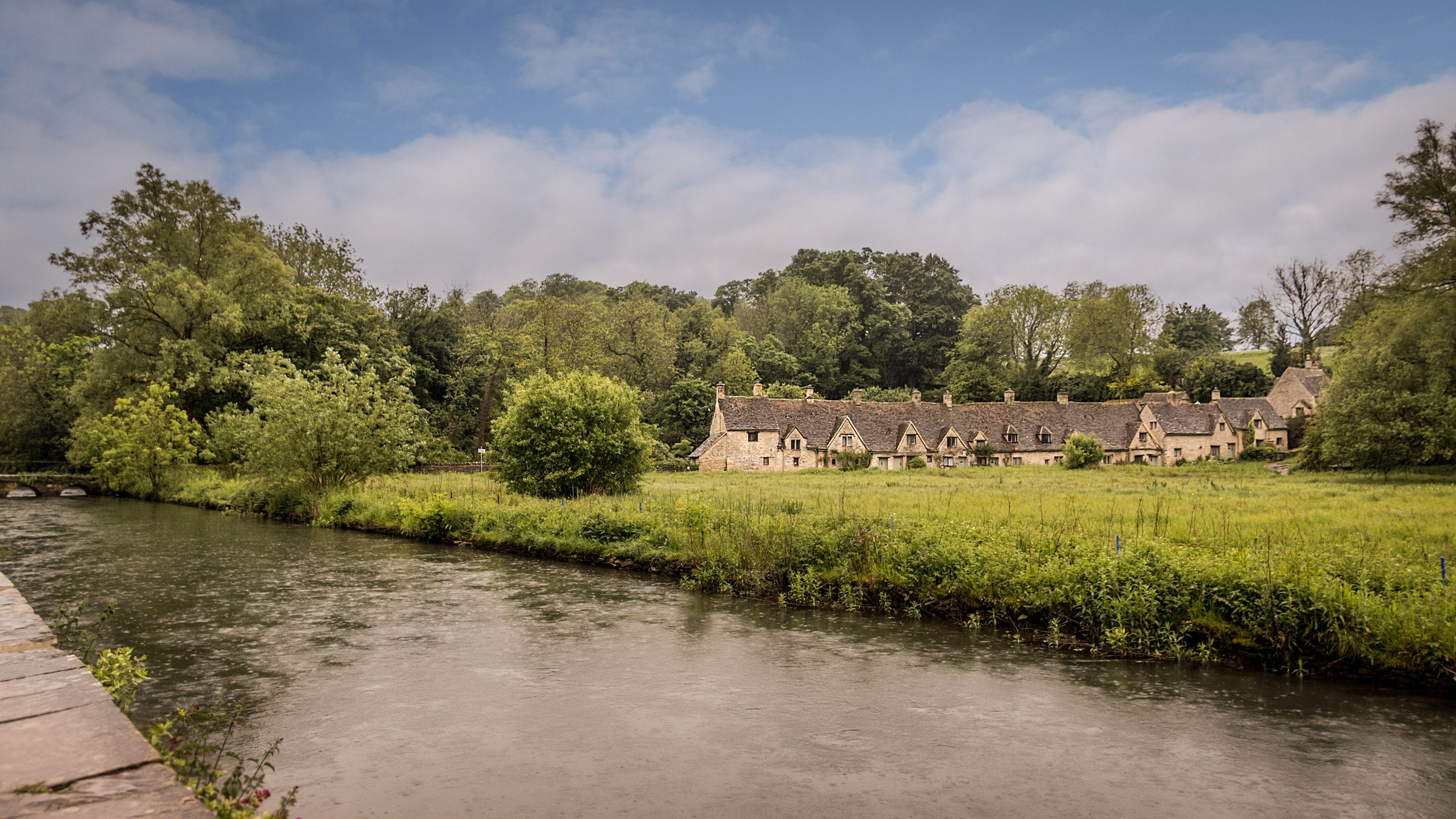 Arlington Row from across the River Coln and water meadow, Gloucestershire