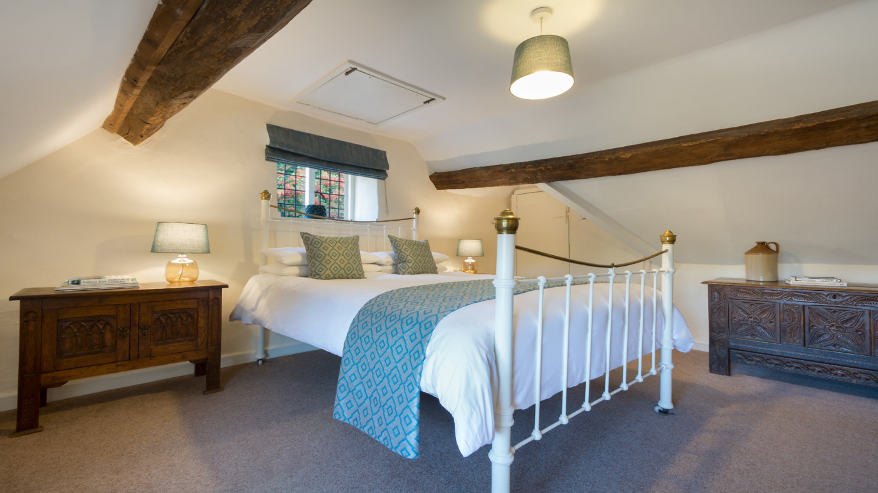 The king-size bedroom  in the eaves of Diston's Cottage, Gloucestershire