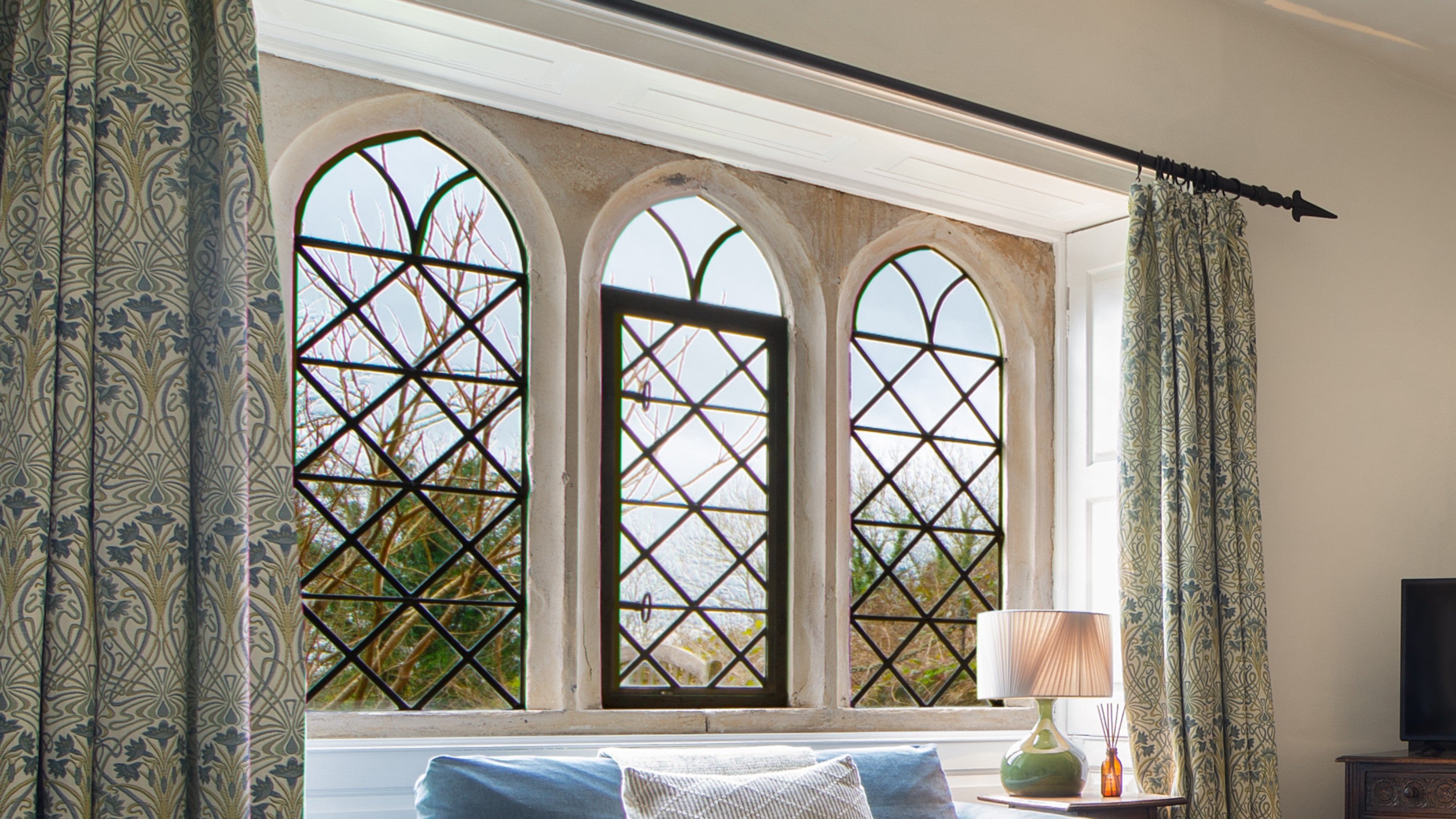 The latticed arched windows at Newark Lower Lodge, Gloucestershire