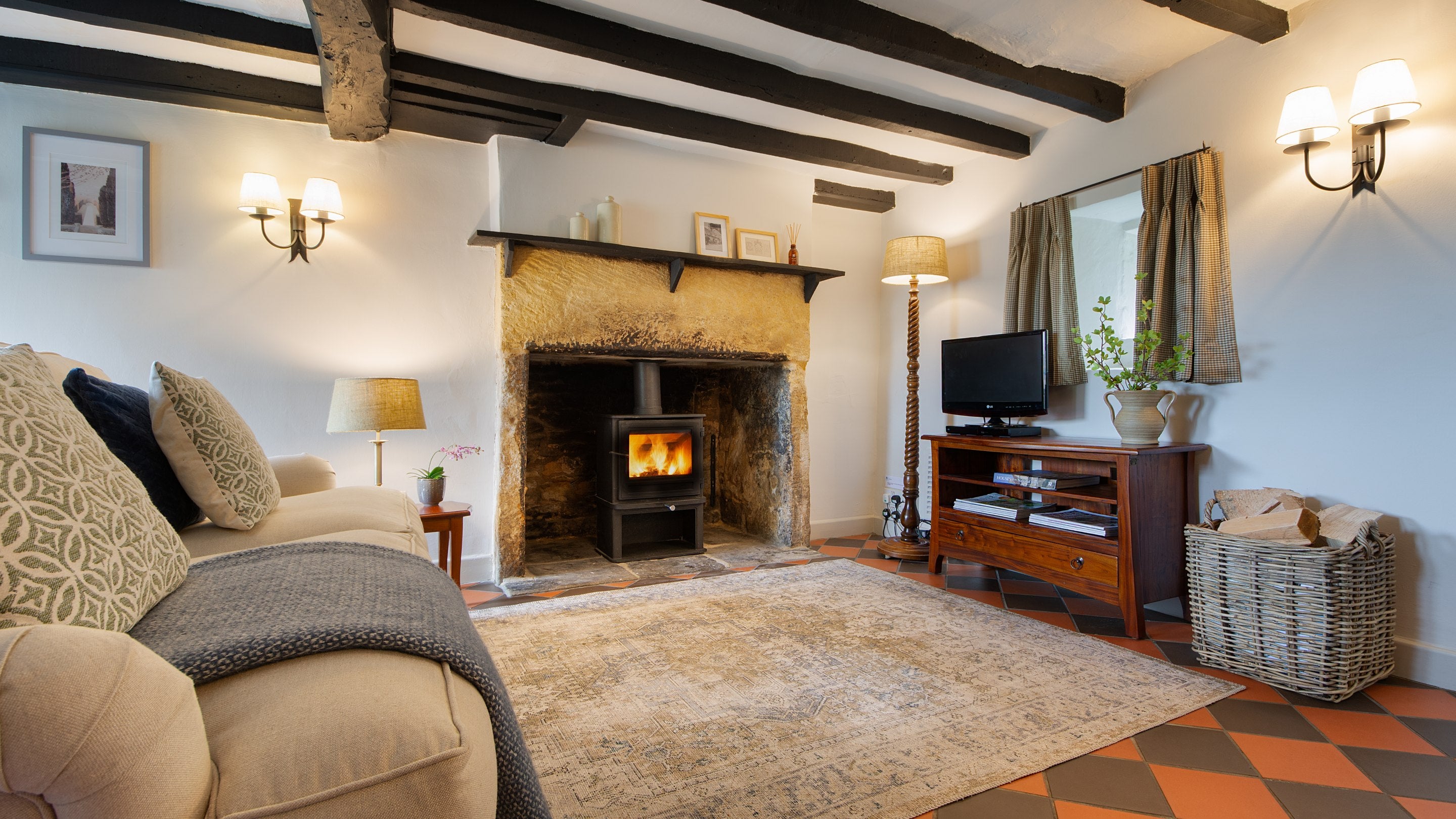 The open-plan sitting and dining room with television at Spring Cottage, Gloucestershire