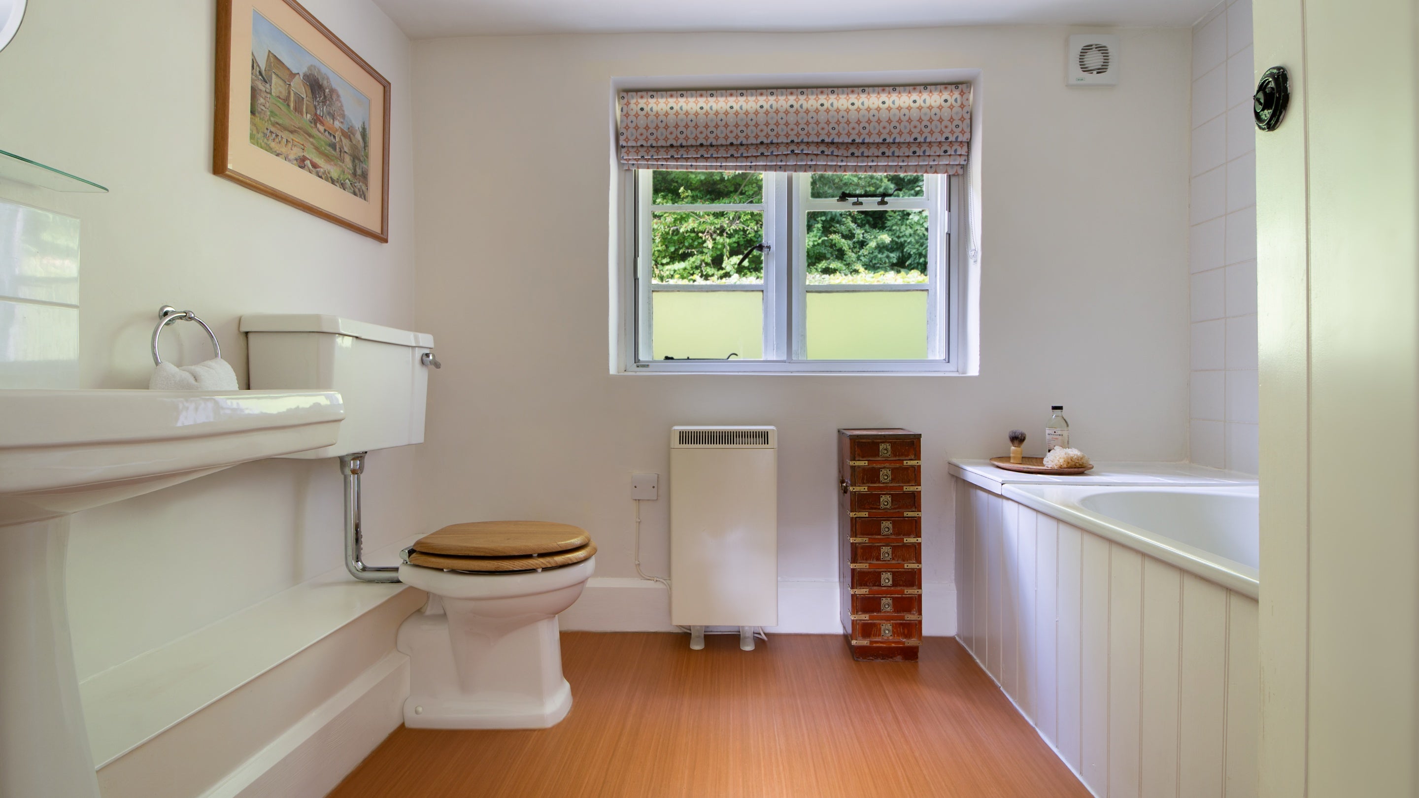 The bathroom with bath with shower attachment (no wall hook) at Woody's Cottage, Gloucestershire