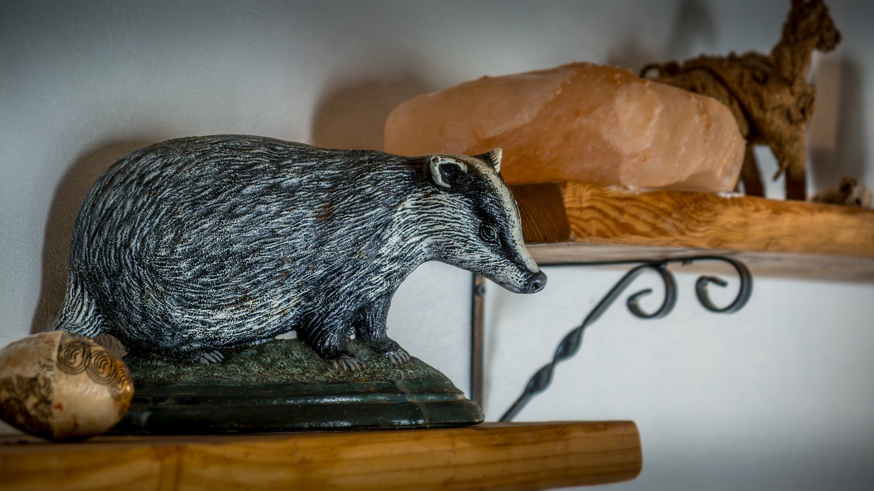 A badger ornament on a shelf in the garden room at Woody's Cottage, Gloucestershire