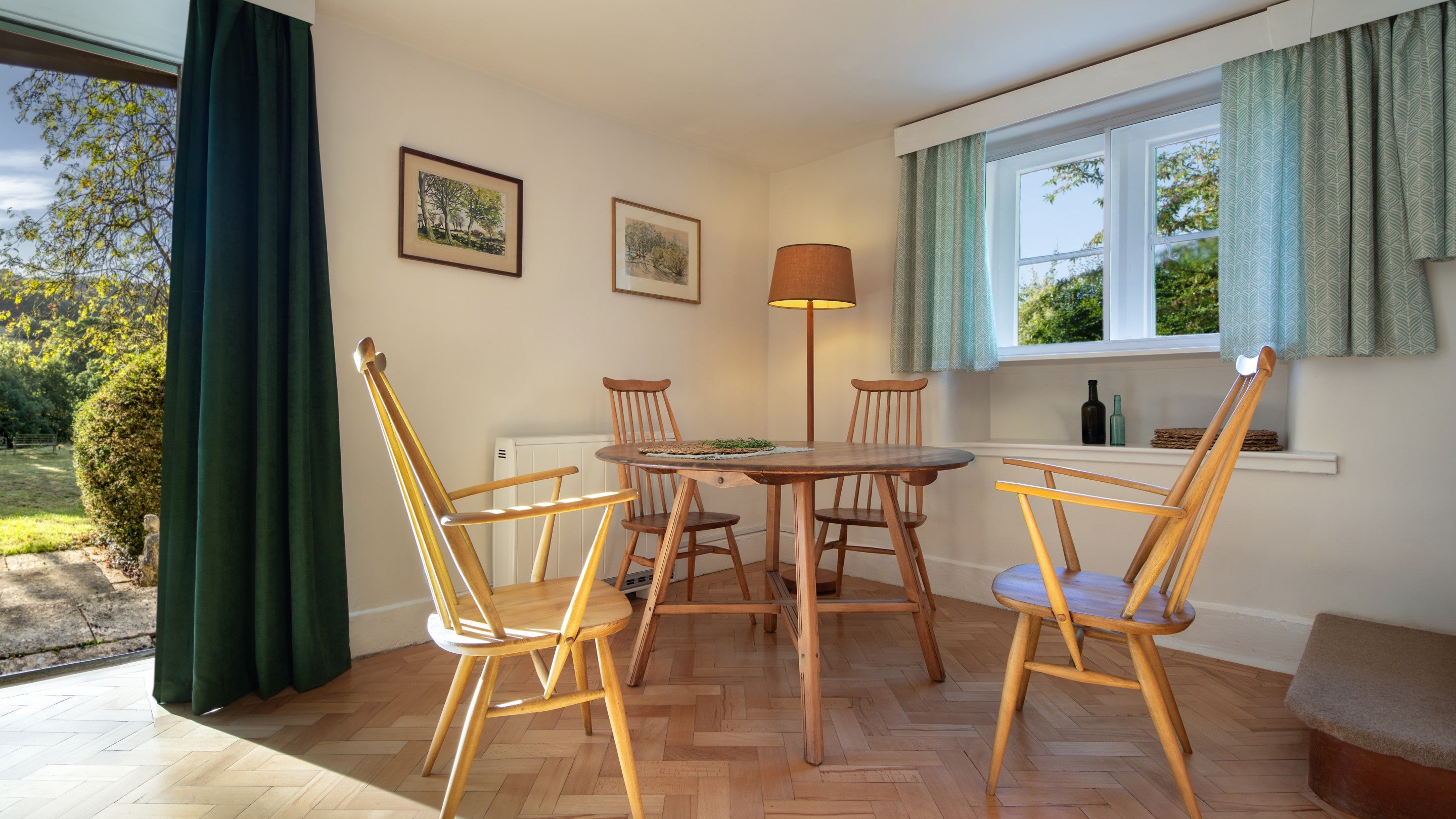 The dining table in the open-plan sitting and dining room at Woody's Cottage, Gloucestershire