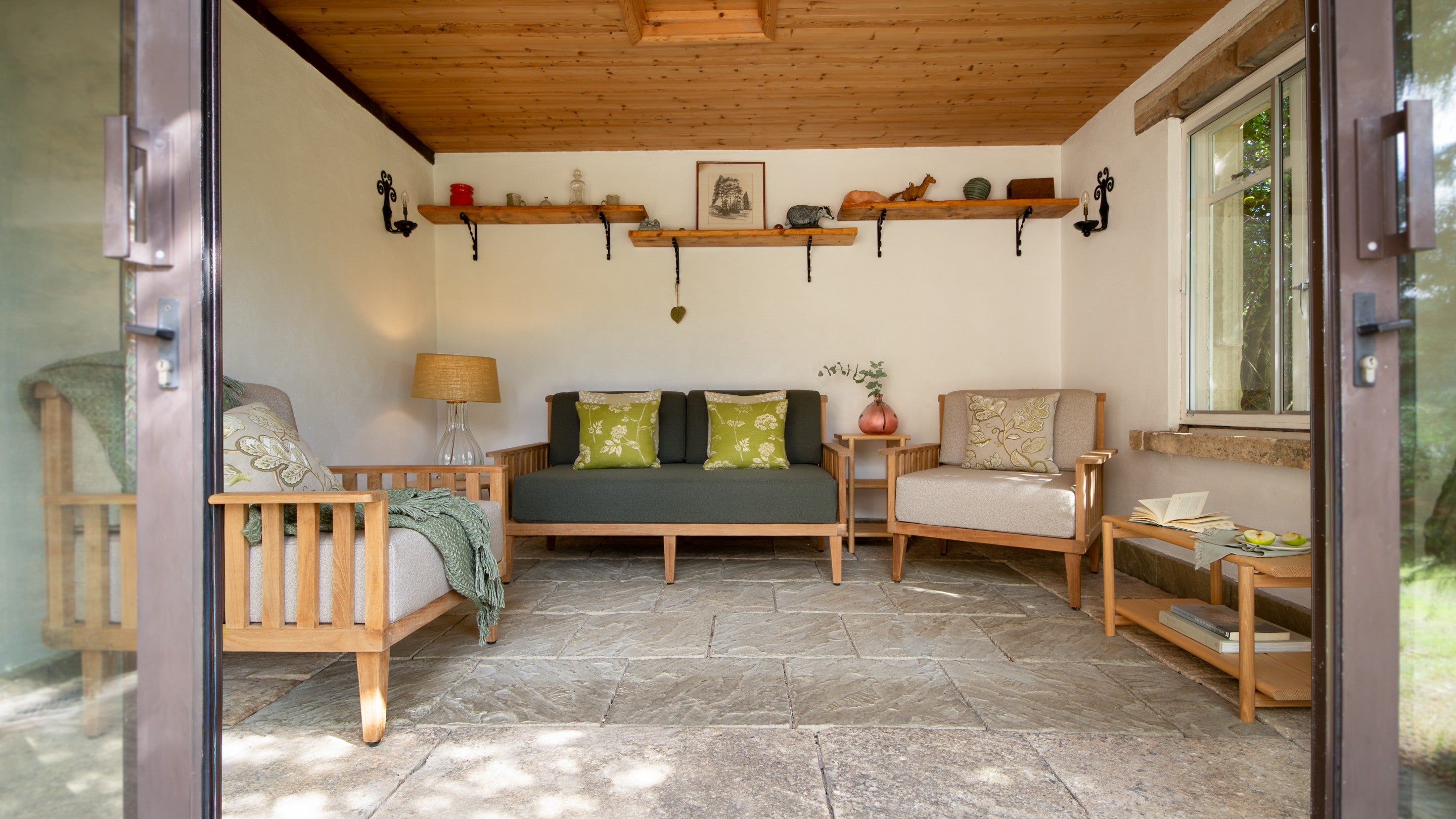 The garden room with sofa and armchairs at Woody's Cottage, Gloucestershire