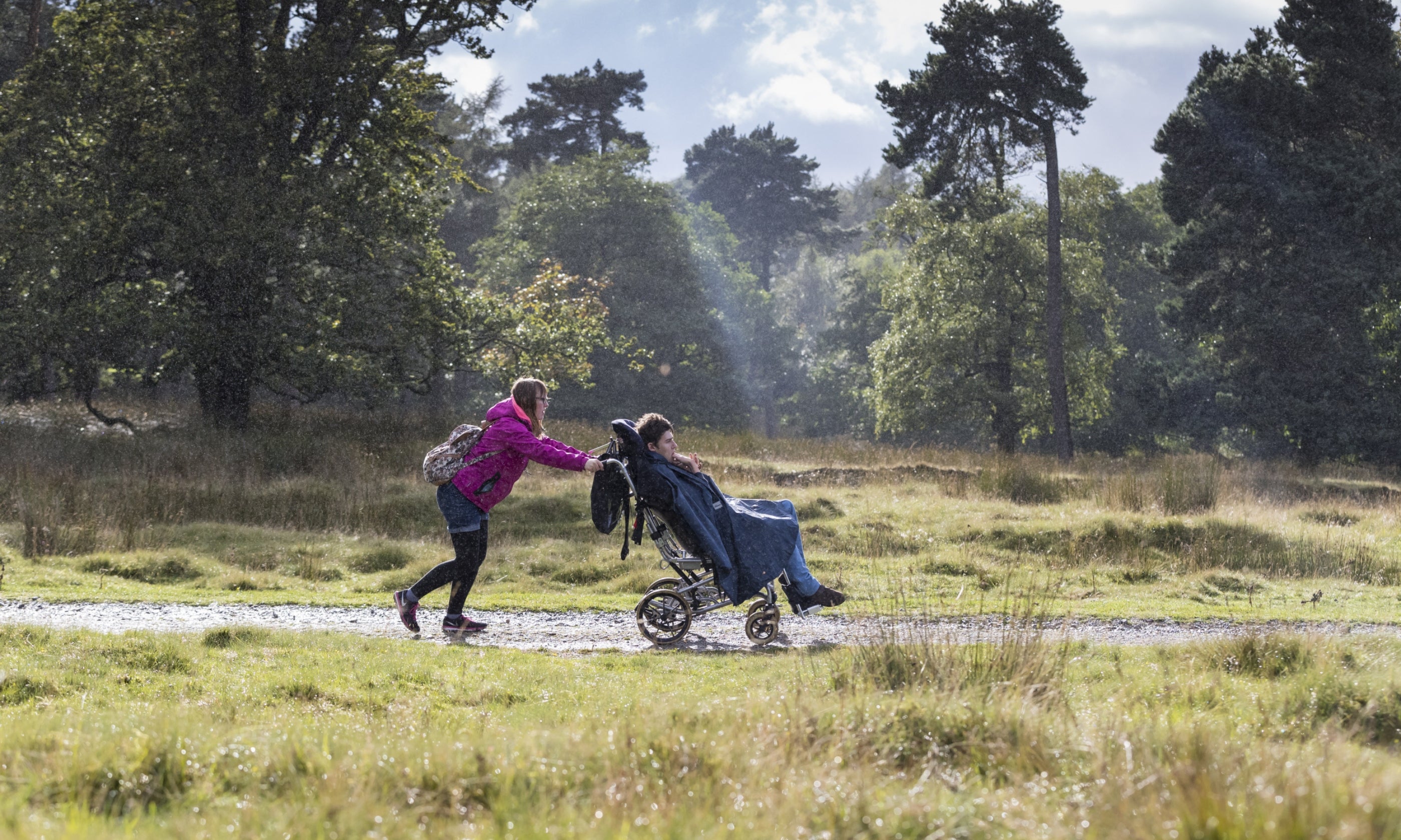 Visitors walking along the accessible path at Longshaw, Burbage and the Eastern Moors, Derbyshire