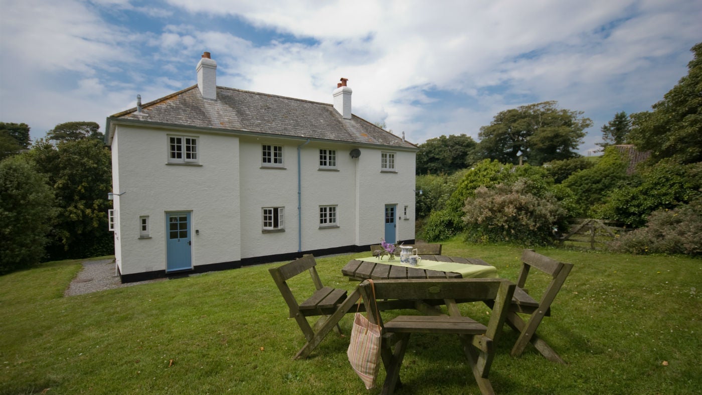 The whitewashed exterior of 1 Coleton Barton, Kingswear, Devon