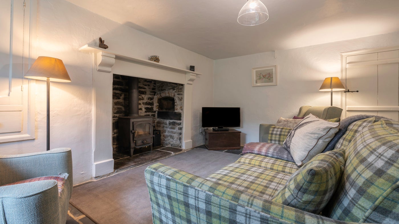 The cosy sitting room at Combe Cottage, Devon