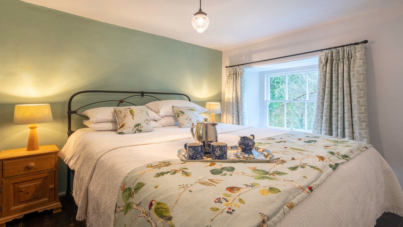 The bright double bedroom at Combe Cottage, Devon