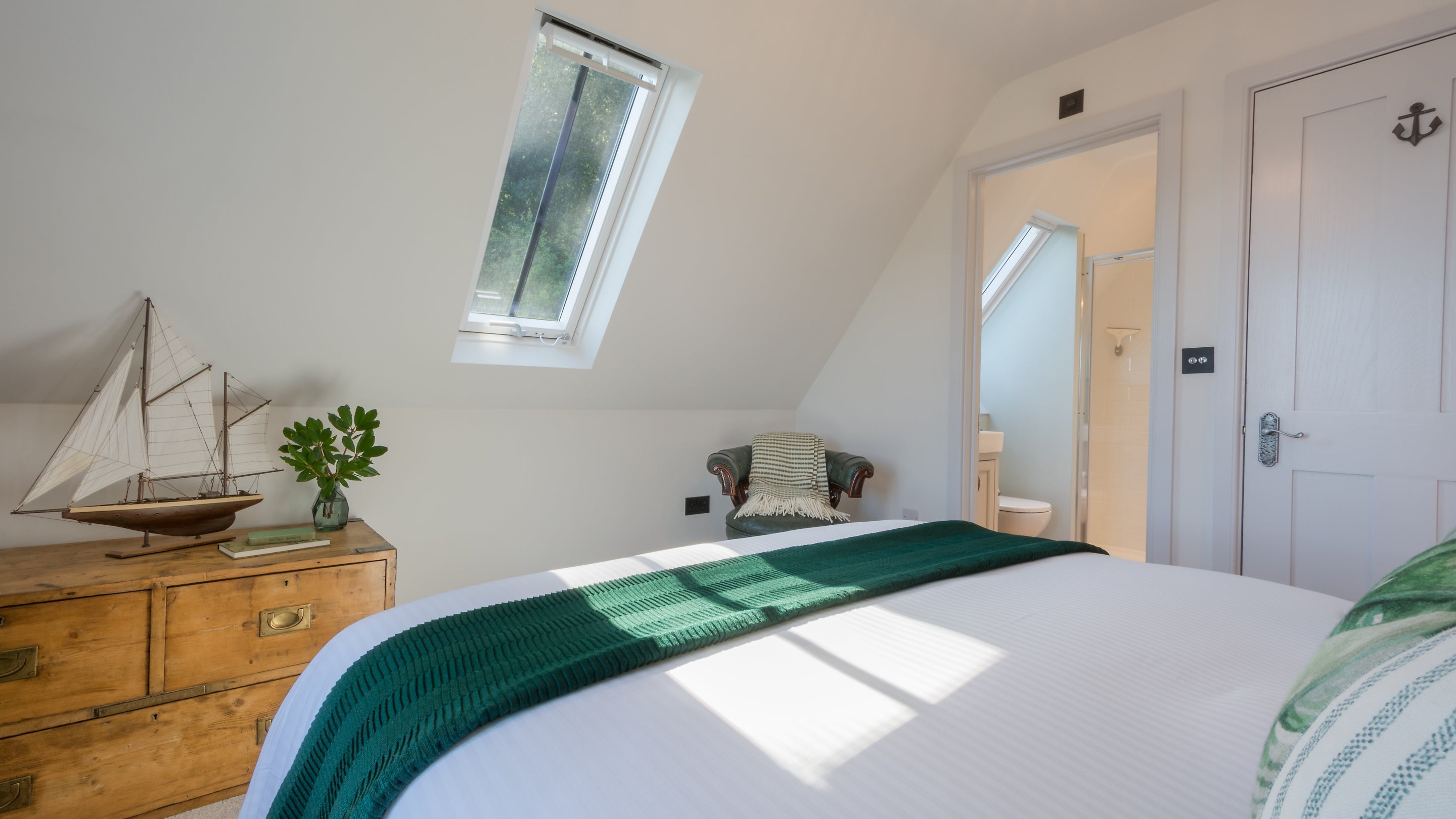 The second-floor double bedroom and entrance to the en-suite shower room at Compass Cottage, Devon