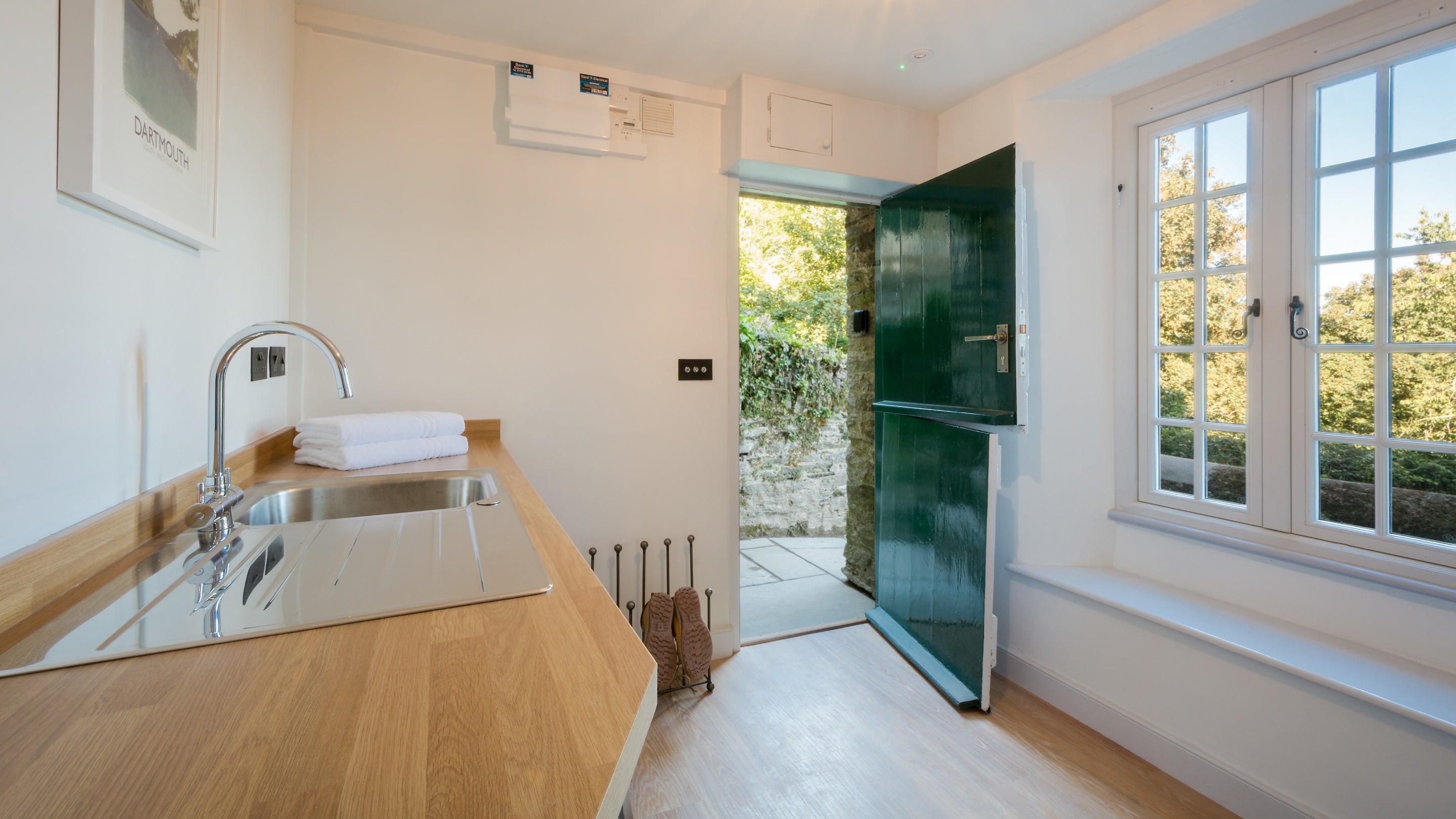 The utility room at Compass Cottage, with door to the rear garden, Devon
