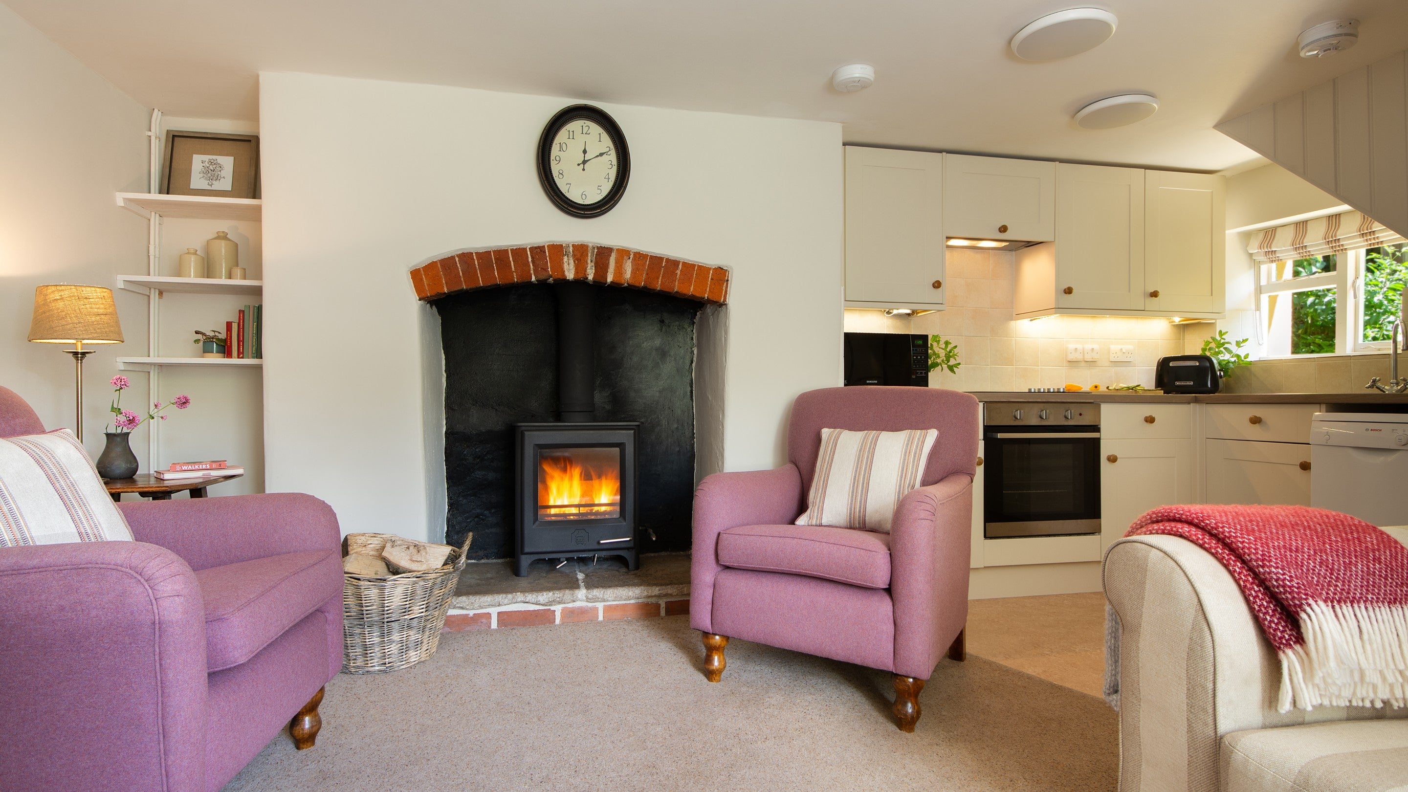 The open-plan kitchen, dining and sitting room, with woodburner at Crockers Cottage, Devon