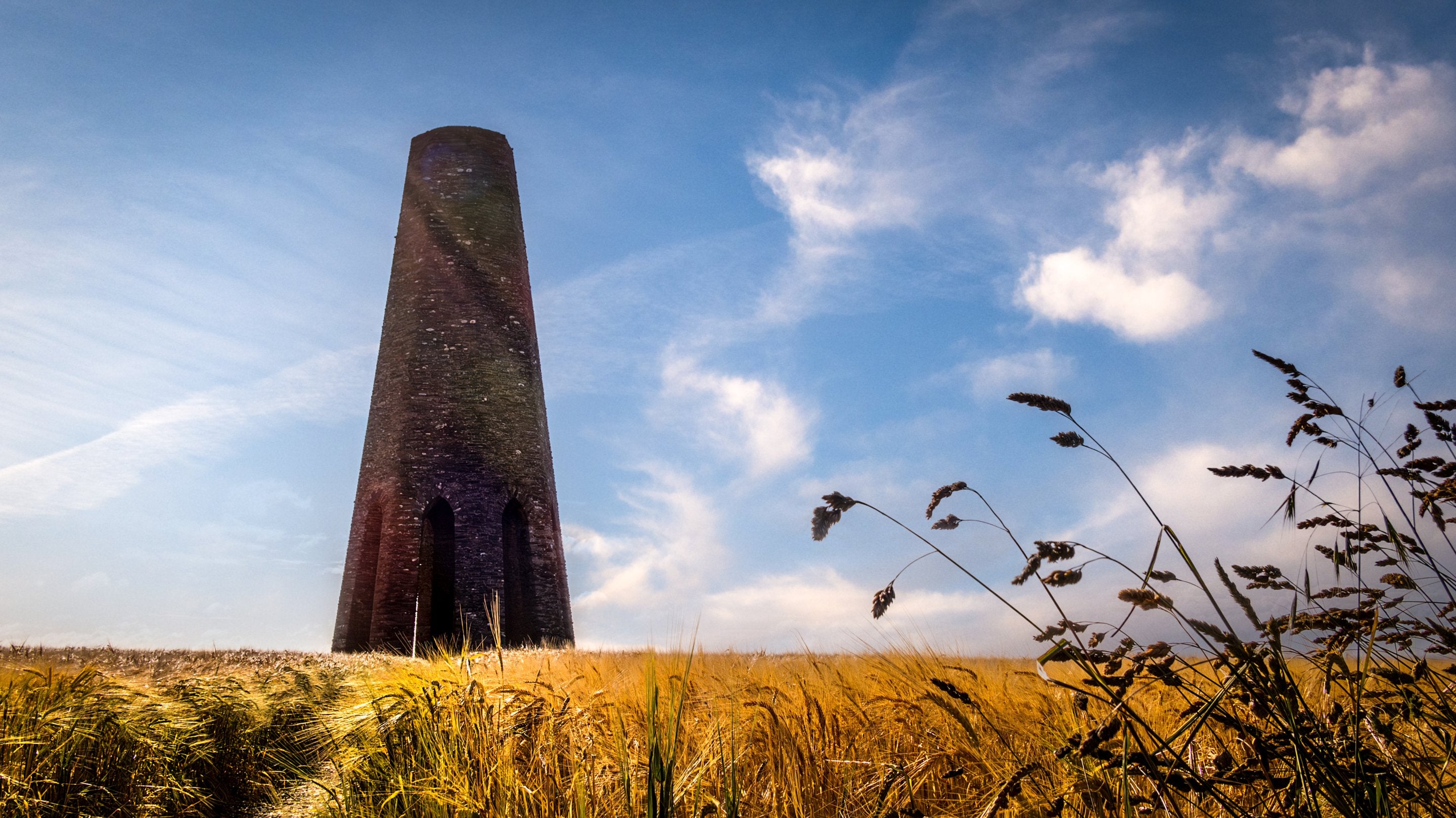 The Daymark, a tower landmark in a wheatfield near Crockers Cottage, Devon