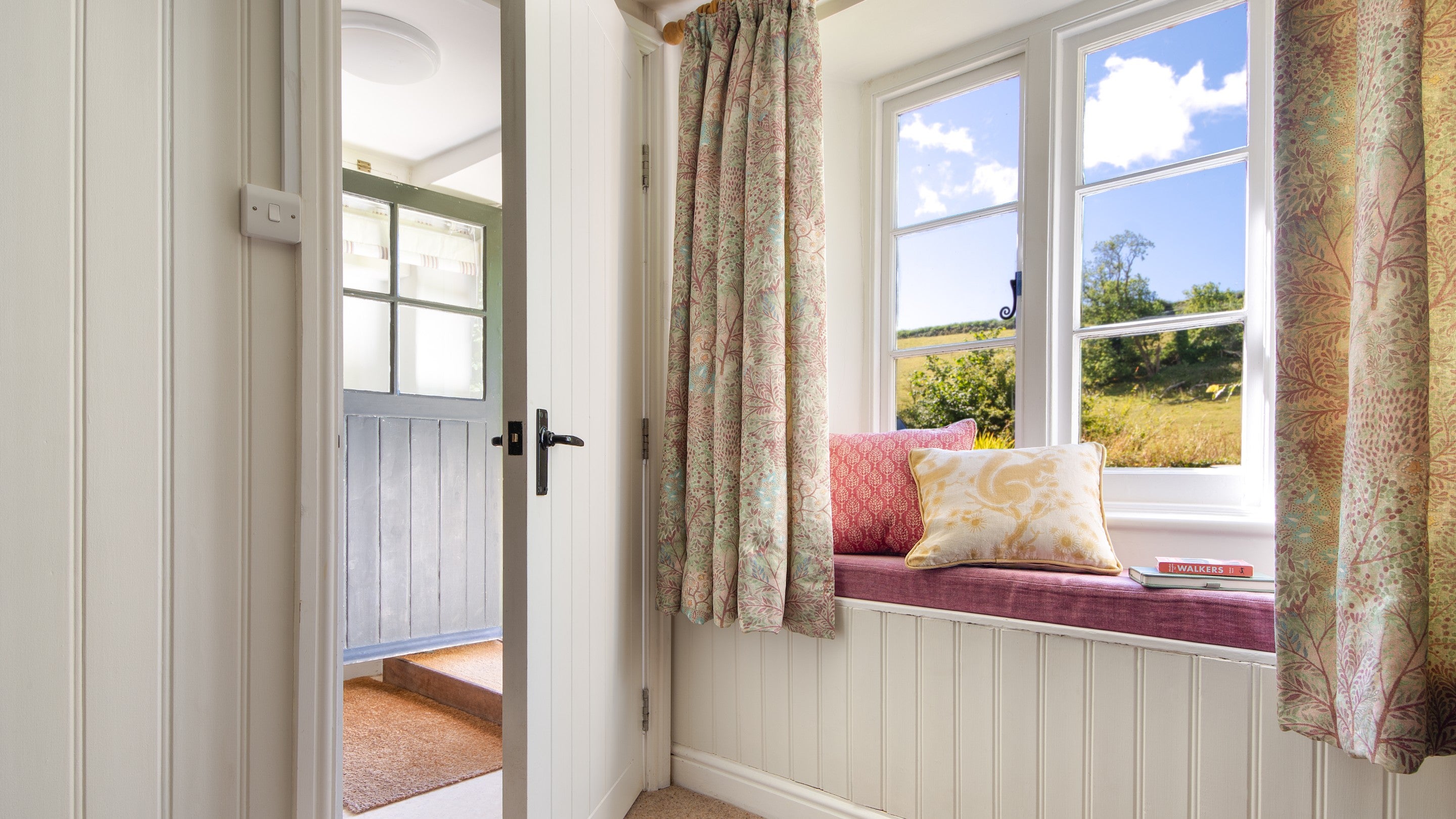 The window seat in the open-plan kitchen, dining and sitting room at Crockers Cottage, Devon