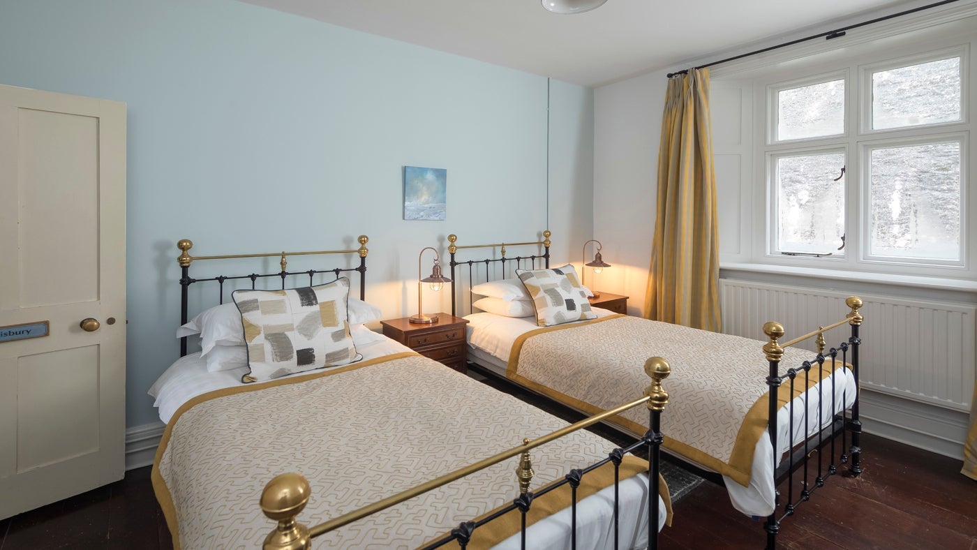 One of the light, airy twin bedrooms at The Lighthouse Keepers' Cottage, Foreland Point, Lynton, Devon
