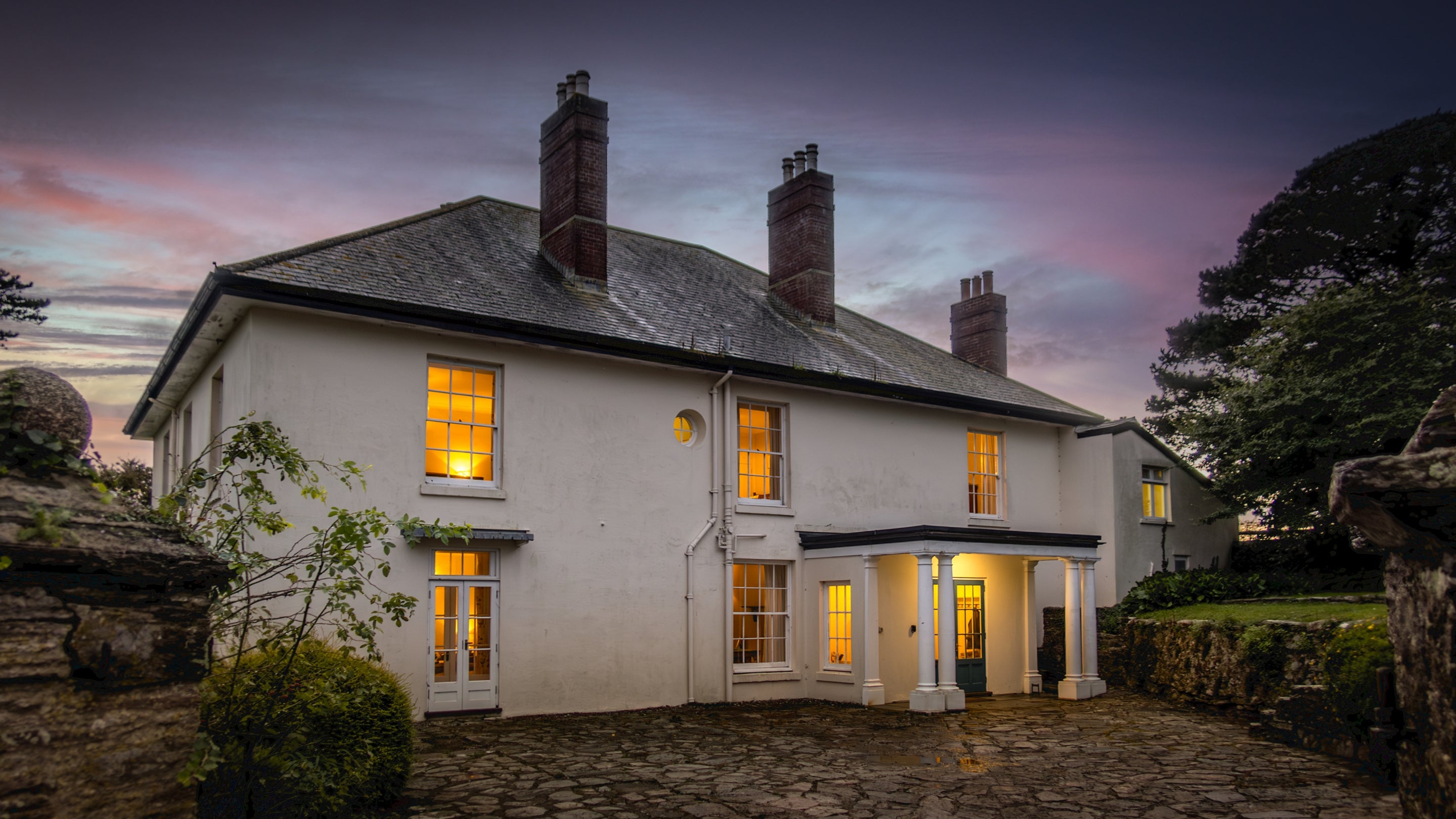 The exterior at night fall at Higher Brownstone Farm, Devon