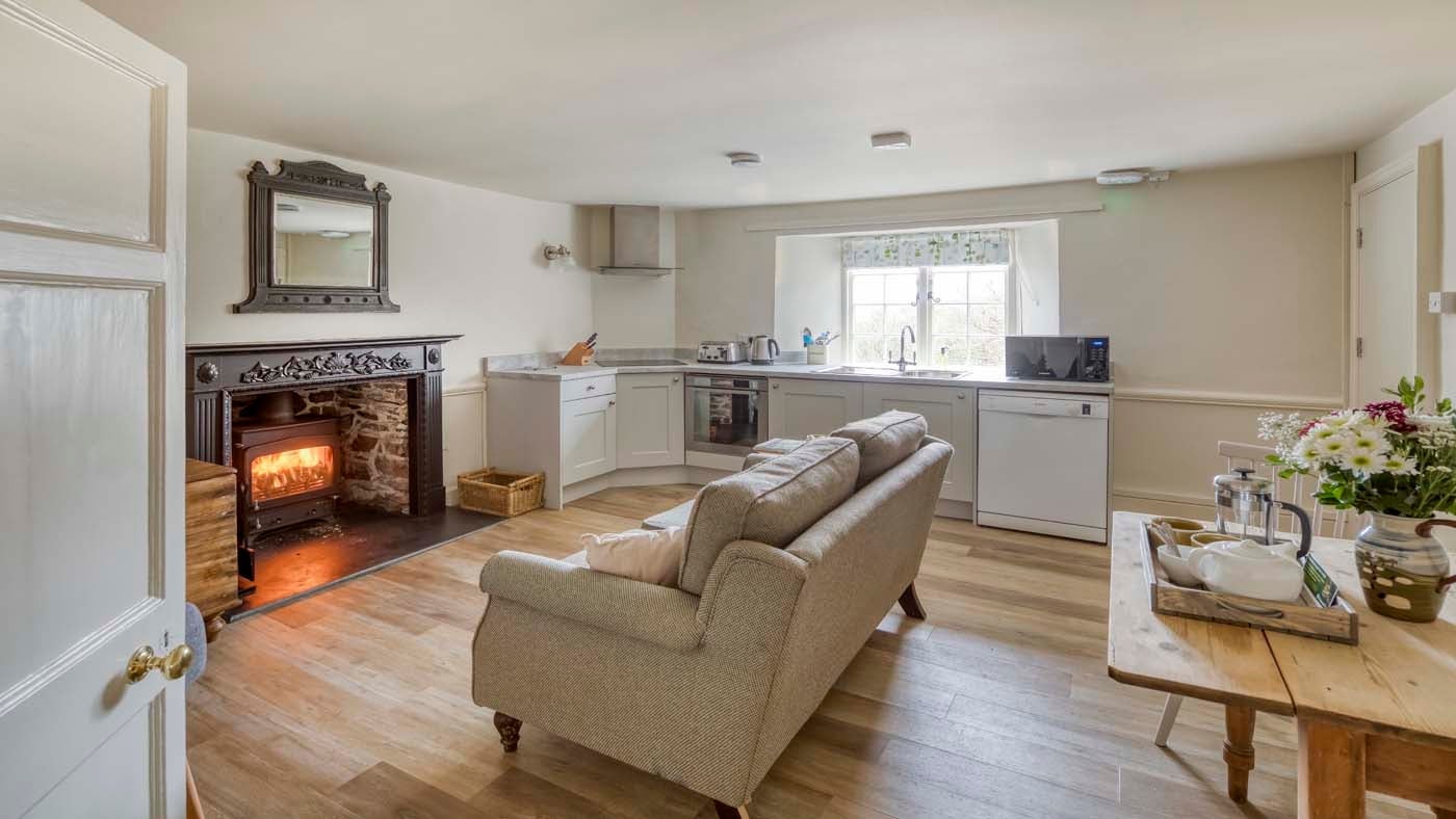 The open plan sitting room, kitchen and dining area at Kipscombe Cottage, Devon
