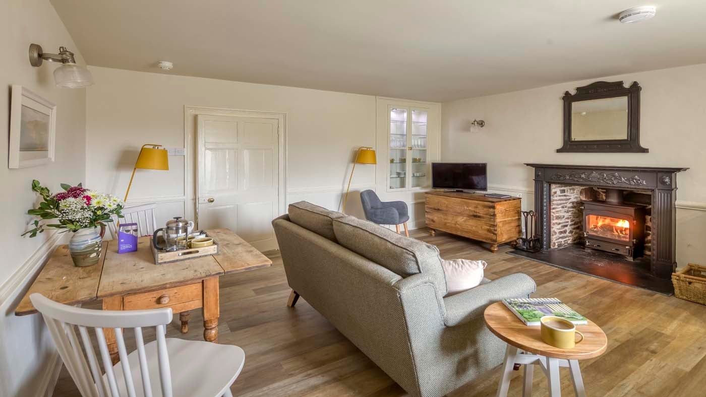 The open plan sitting room, kitchen and dining area at Kipscombe Cottage, Devon