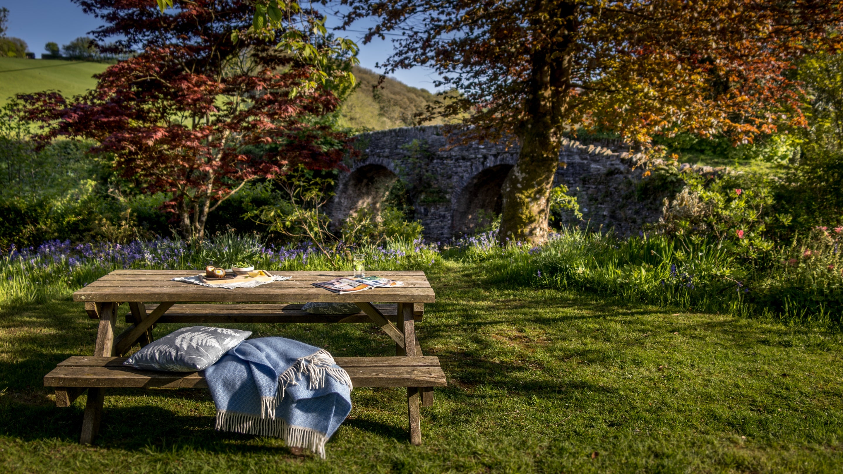 The lawn shared with the tea-room next door at Riverside Cottage, Devon