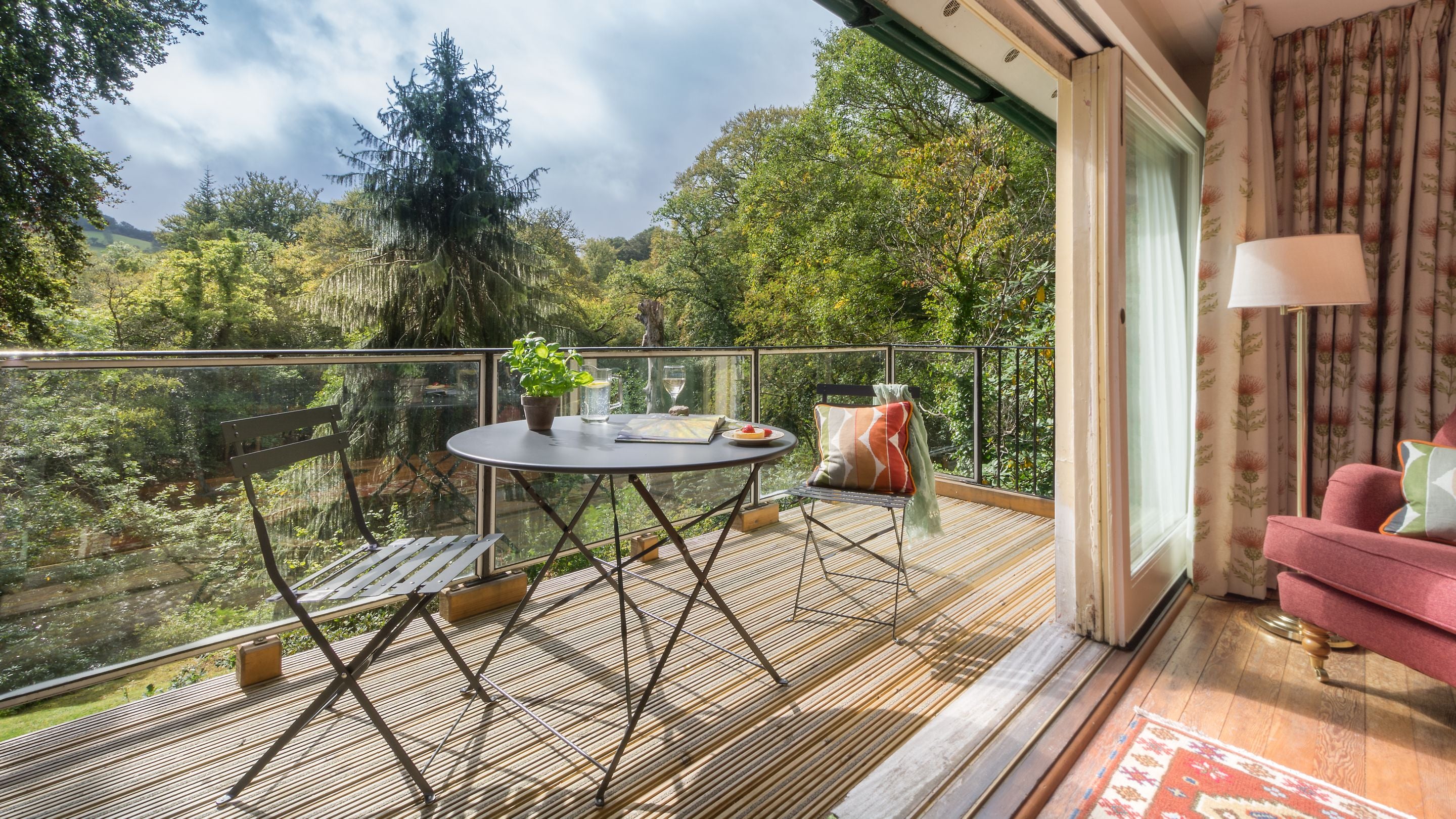 The dining table and chairs for two on the balcony at Warcleave Cottage, Devon