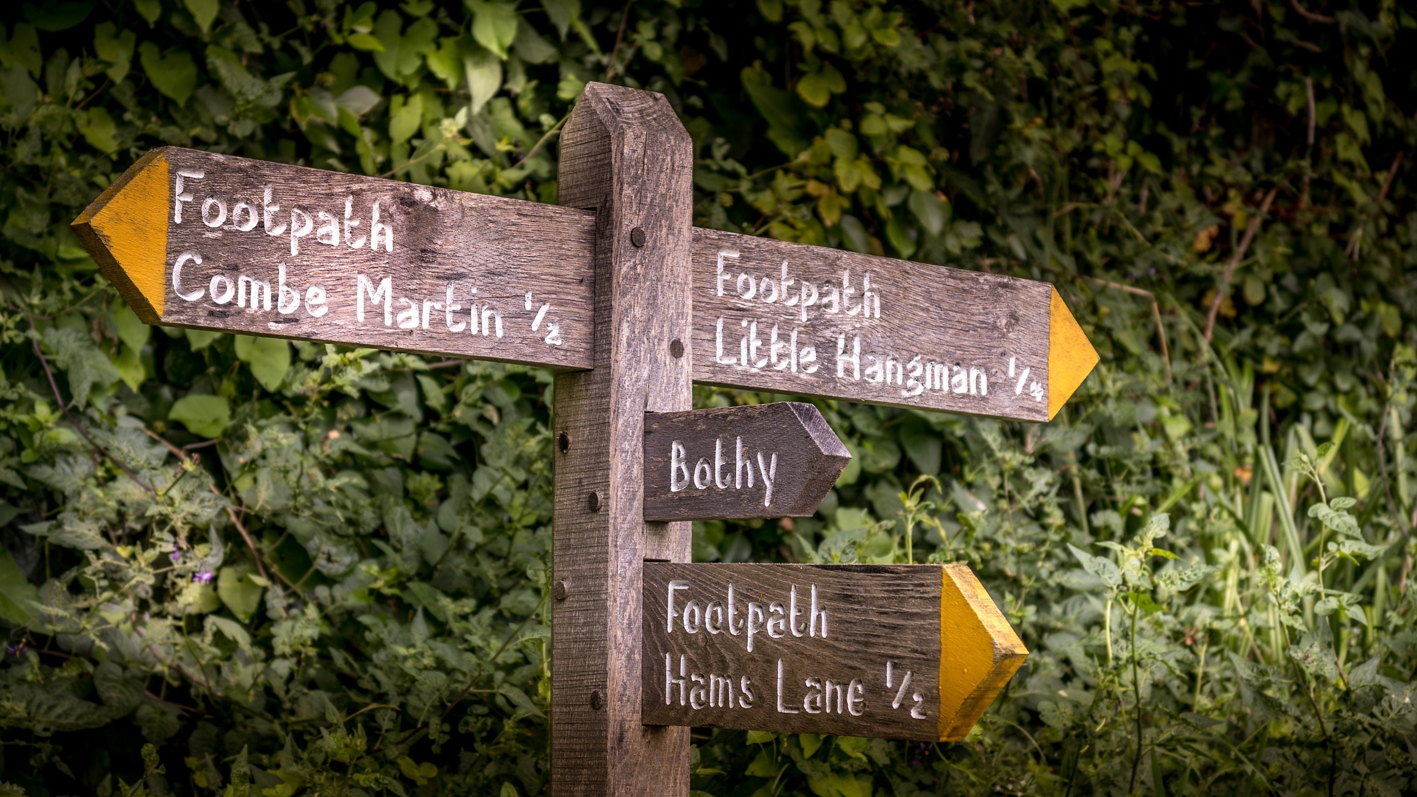 Signs for West Challacombe Bothy and footpaths to Combe Martin village (half a mile away) and Little Hangman Hill (a quarter of a mile away), Devon