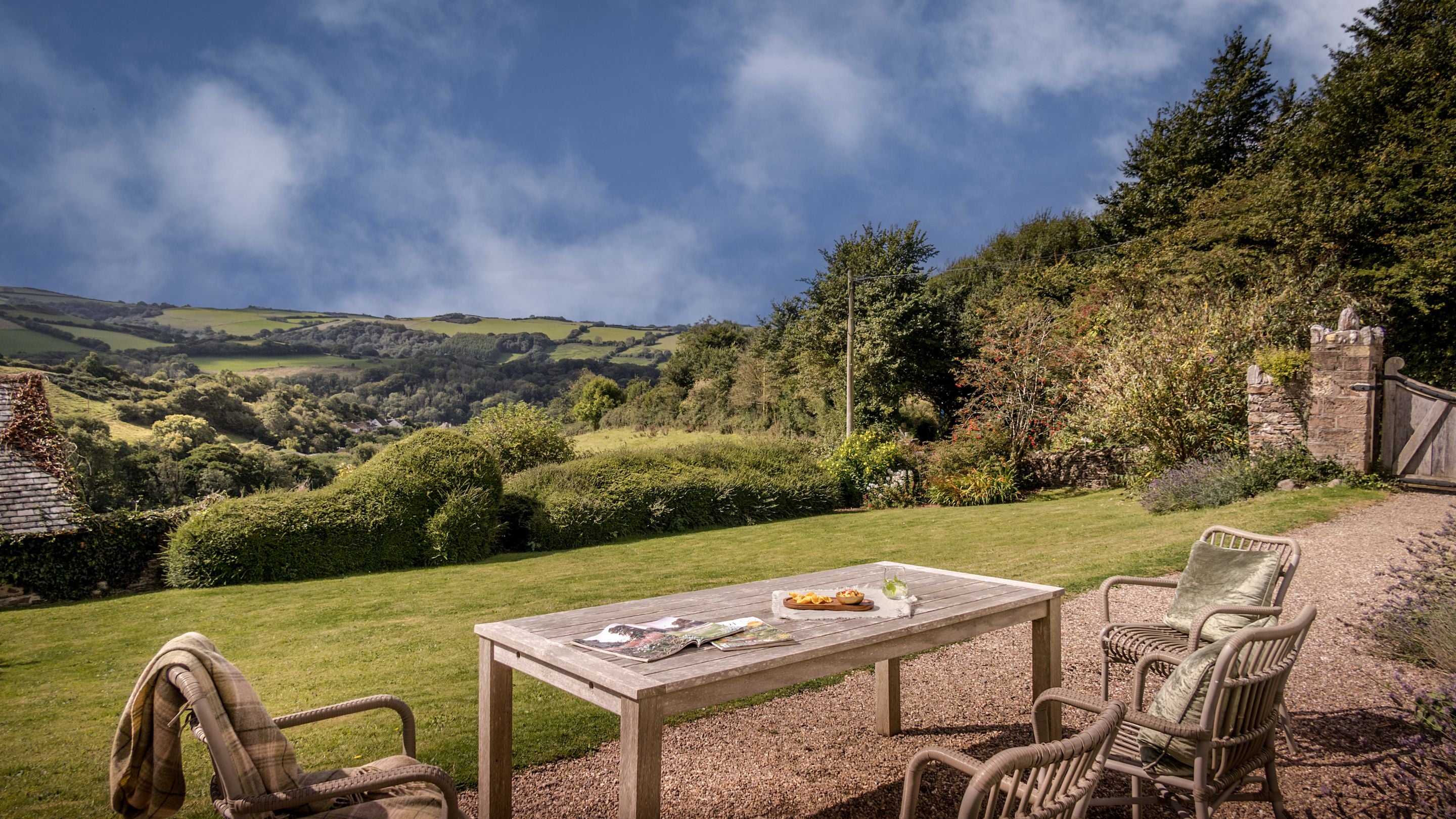 The garden with outdoor dining furniture at West Challacombe Cottage. The garden is shared with West Challacombe Manor, Devon