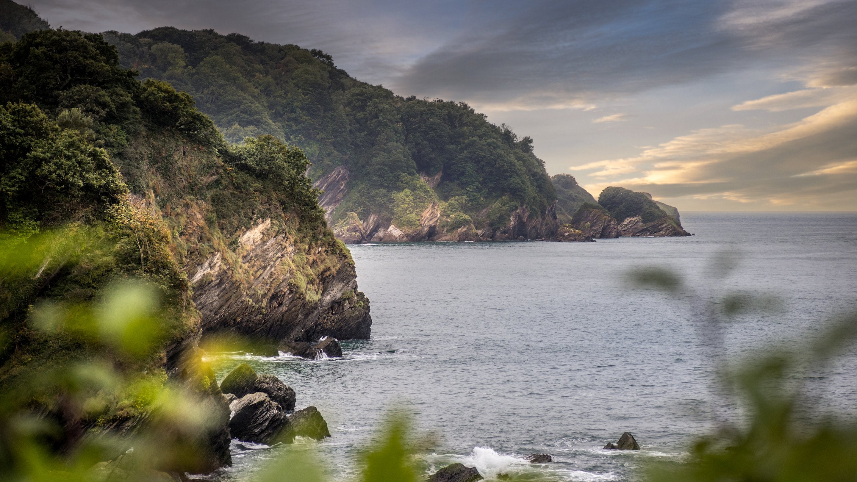 The rocky, tree-lined coast at Combe Martin, near West Challacombe Manor and Cottage, Devon