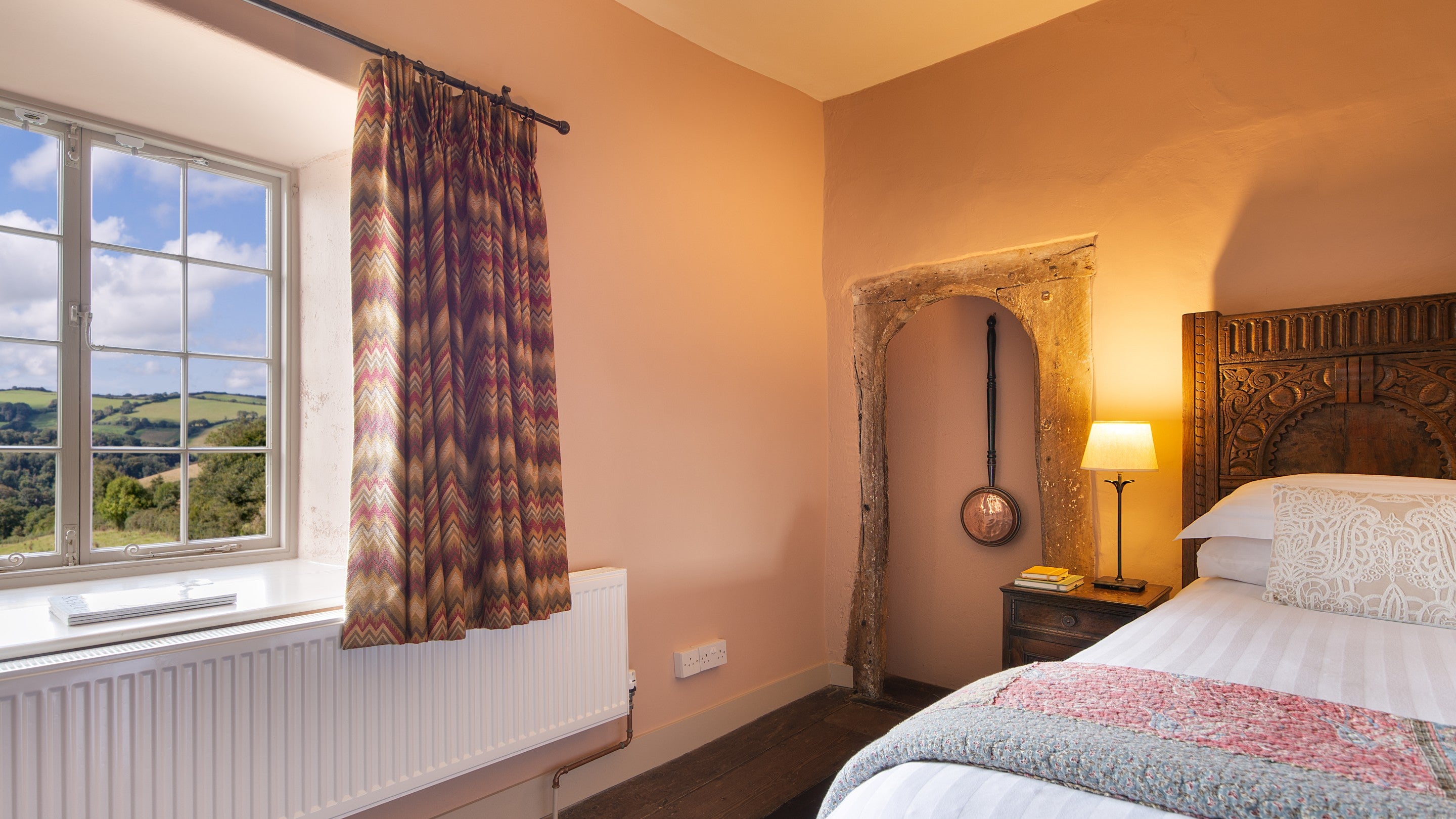 The double bedroom, with views over rolling countryside, at West Challacombe Manor, Devon