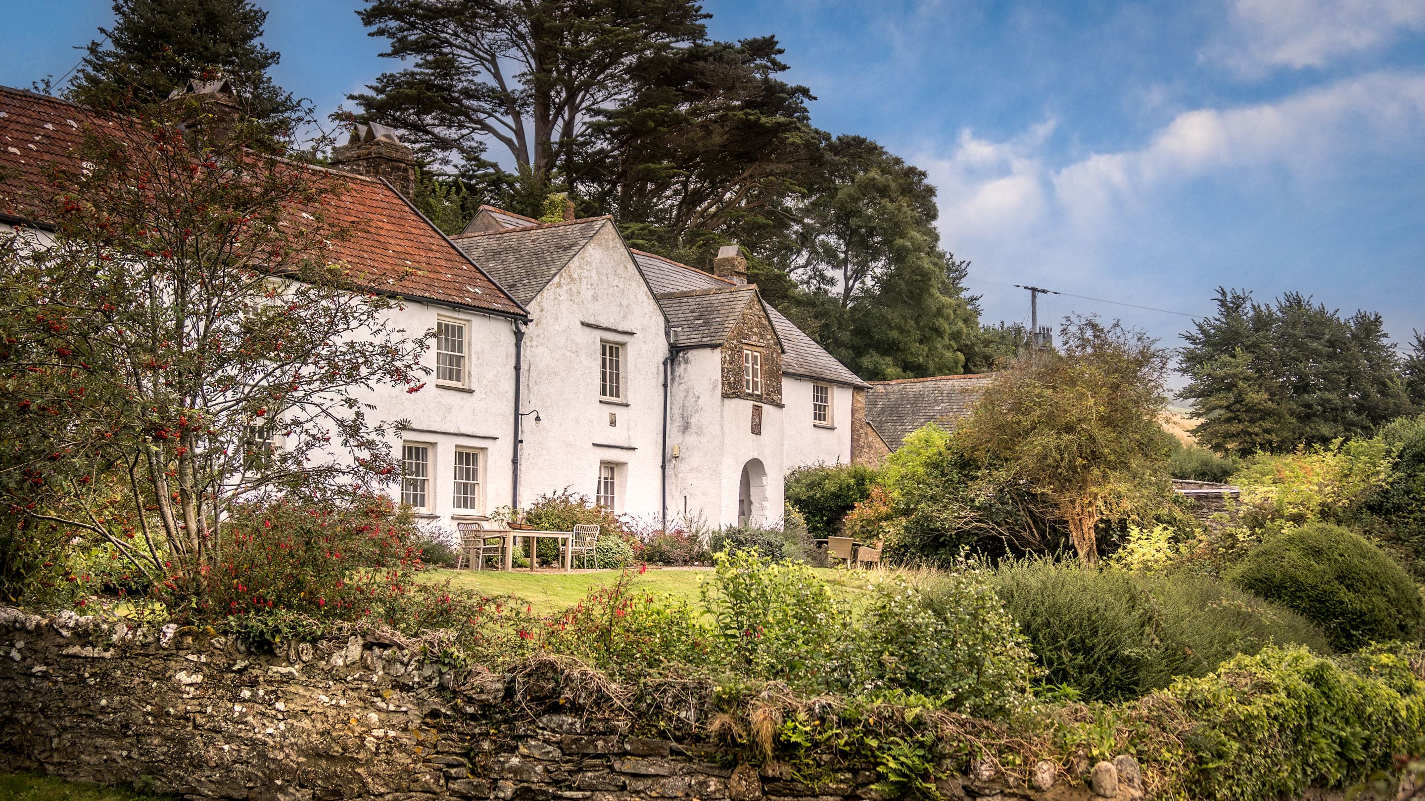 West Challacombe Manor and West Challacombe Cottage next door, with their shared garden in front, Devon