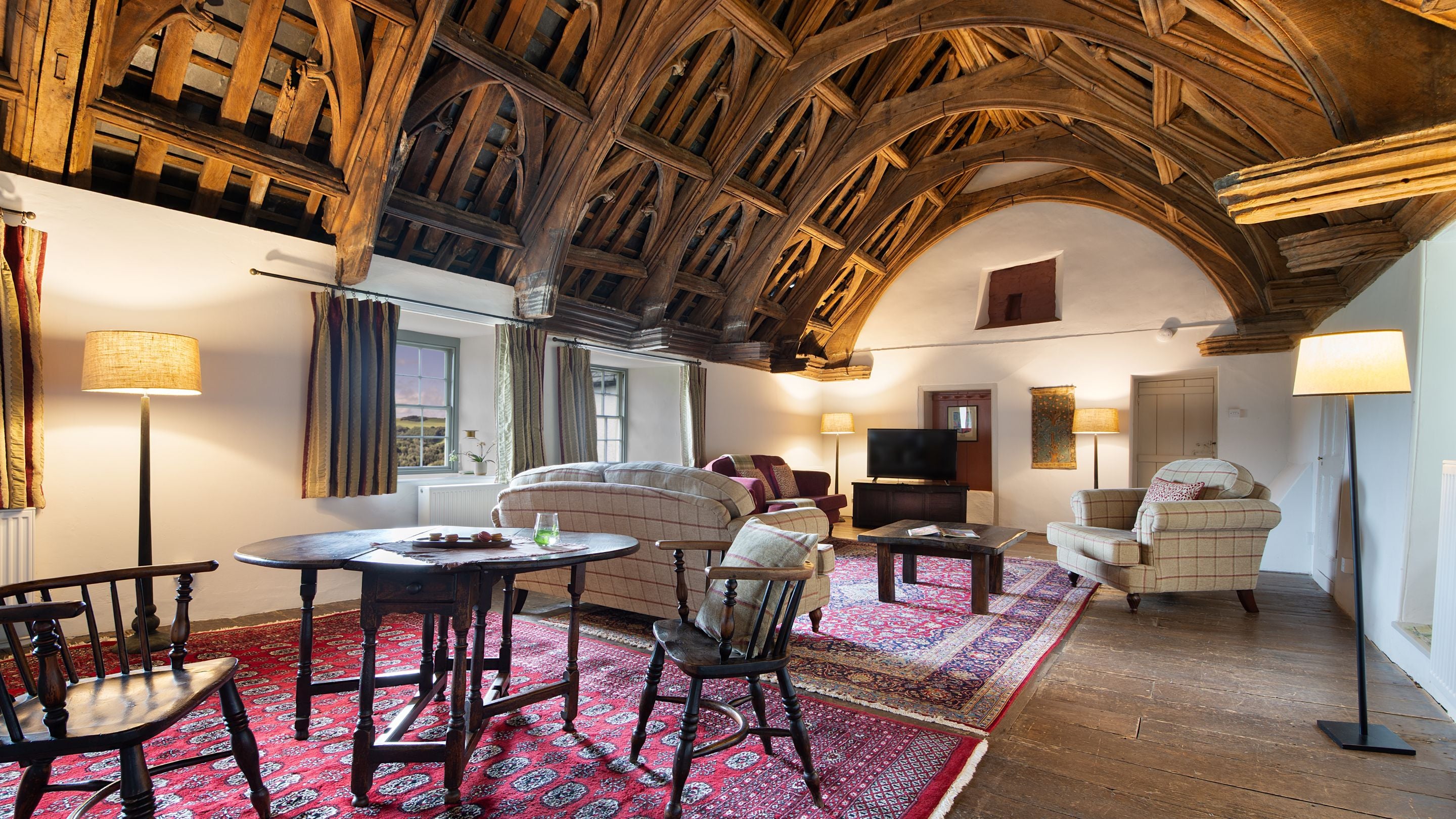 The great hall with original oak hammer beam ceiling at West Challacombe Manor, Devon