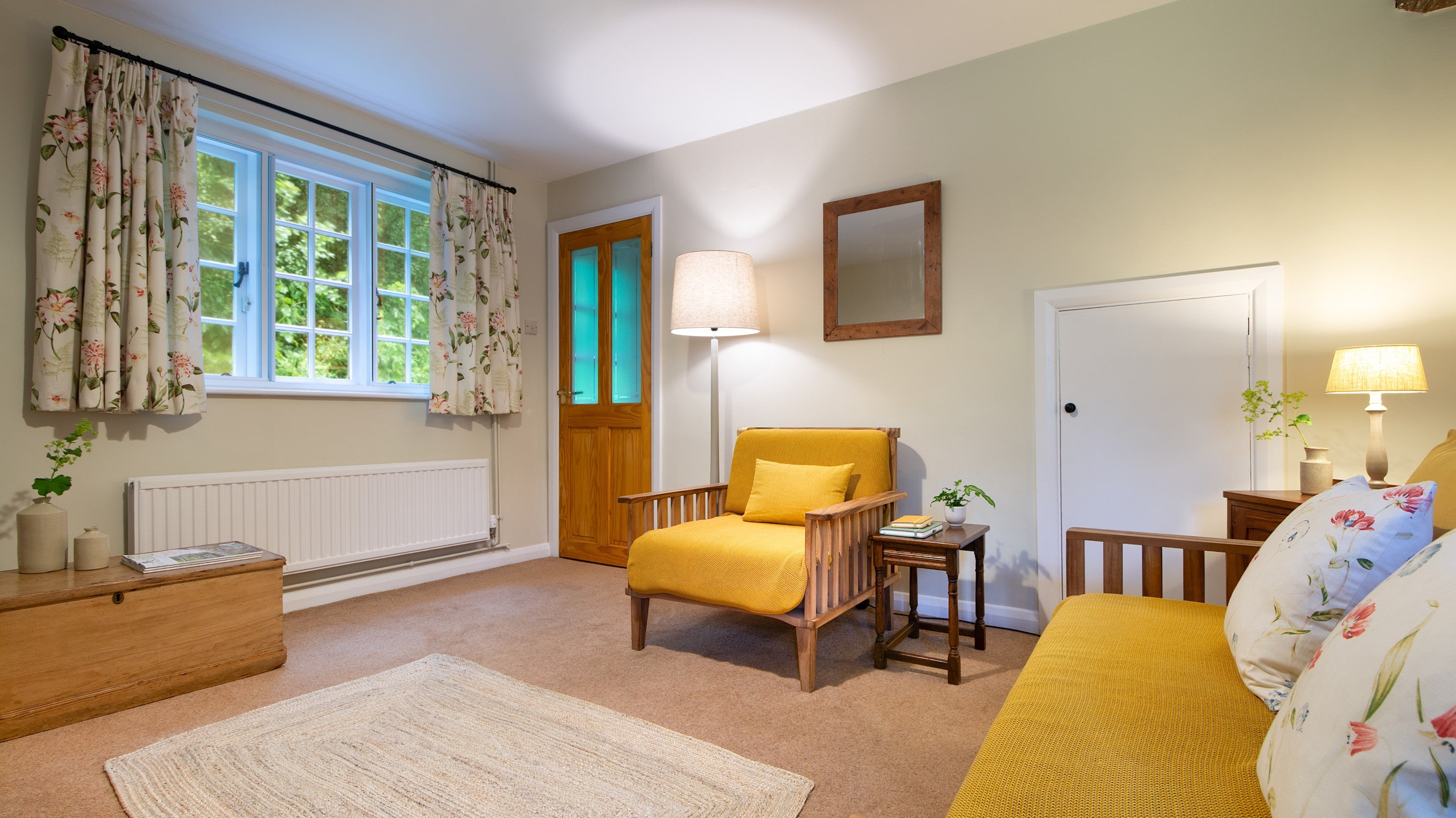 The sitting room at Ash Cottage, with sofa and armchair, Dorset