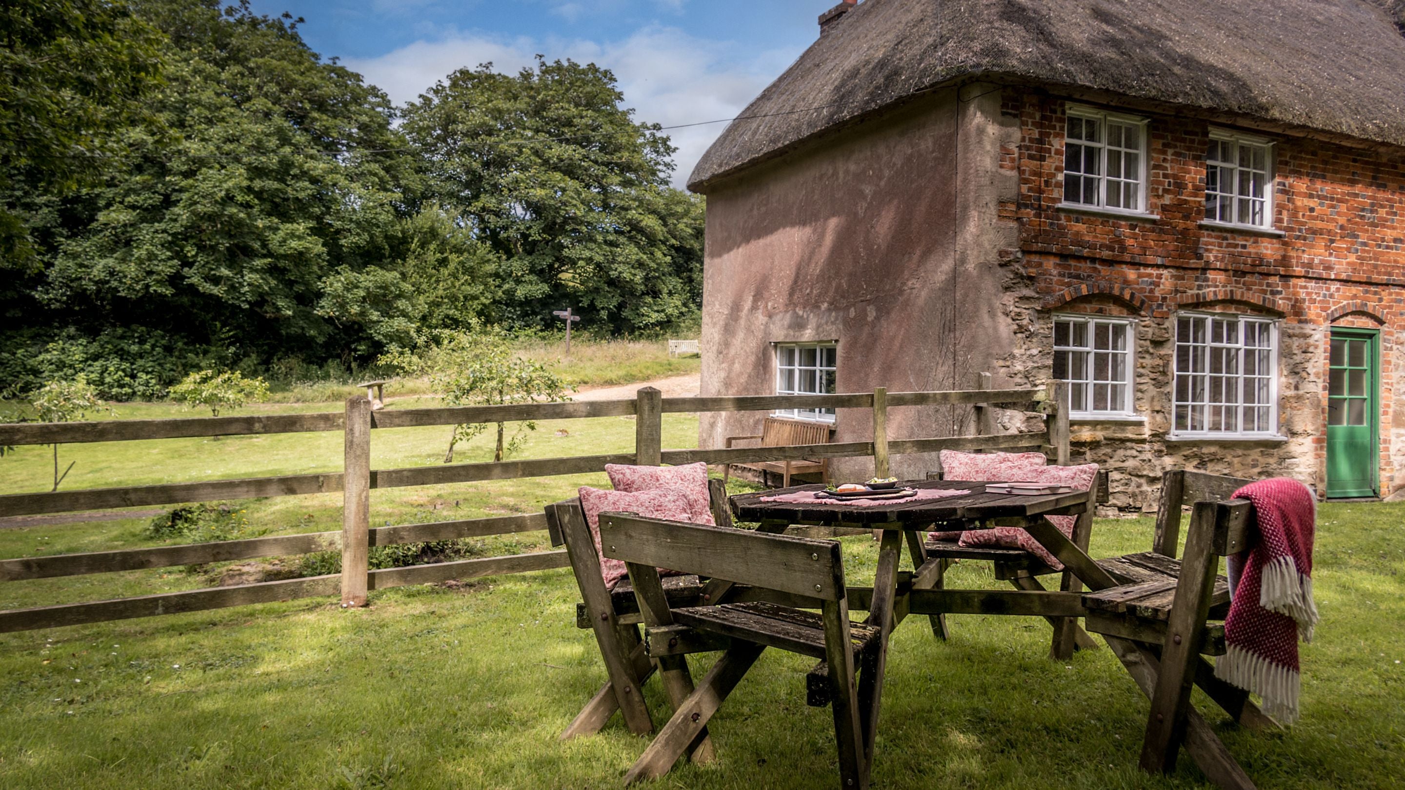 Beech Cottage with picnic bench in the shared garden, Dorset
