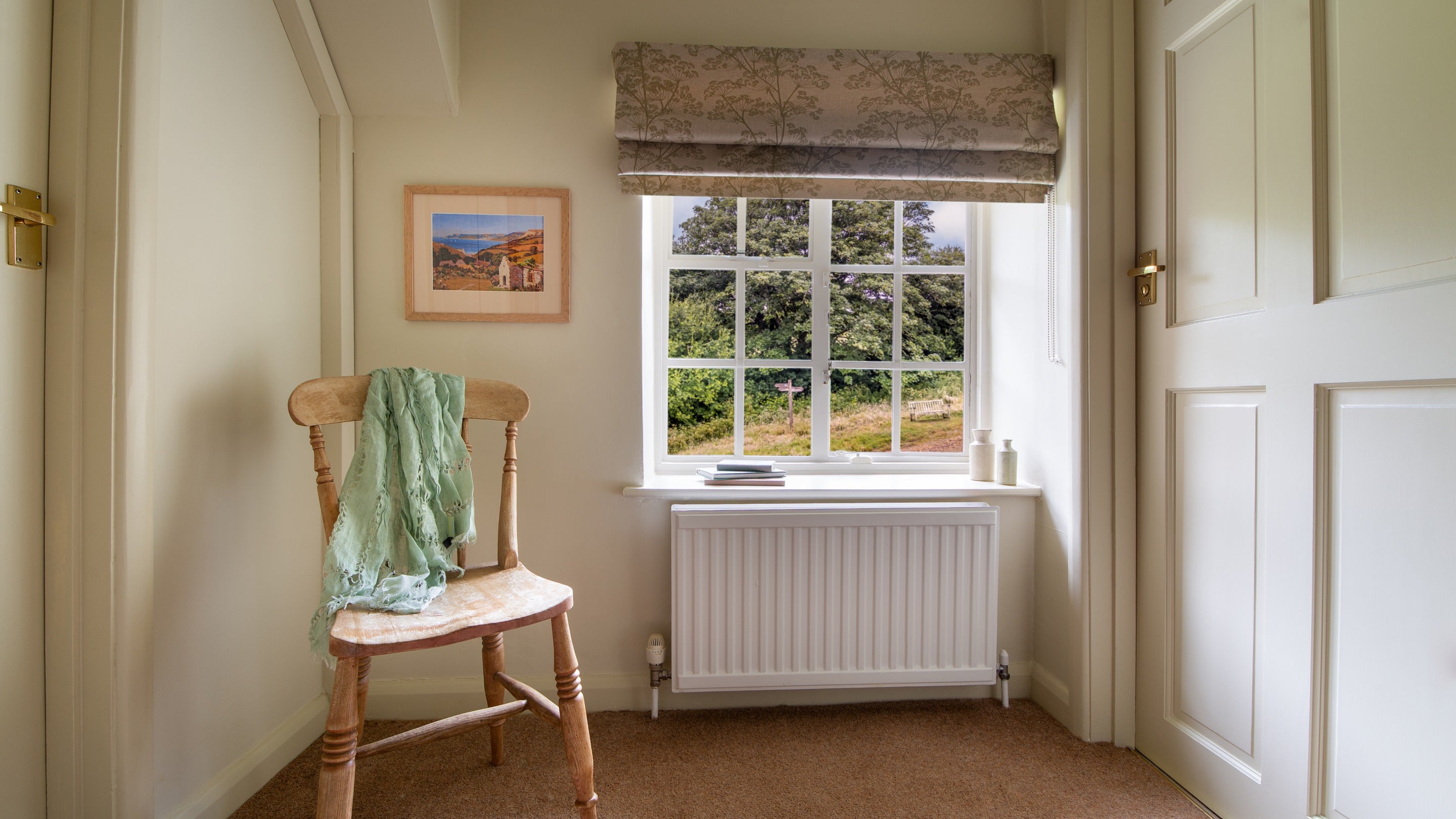 The landing on the first floor of Beech Cottage, with views of woodland, Dorset