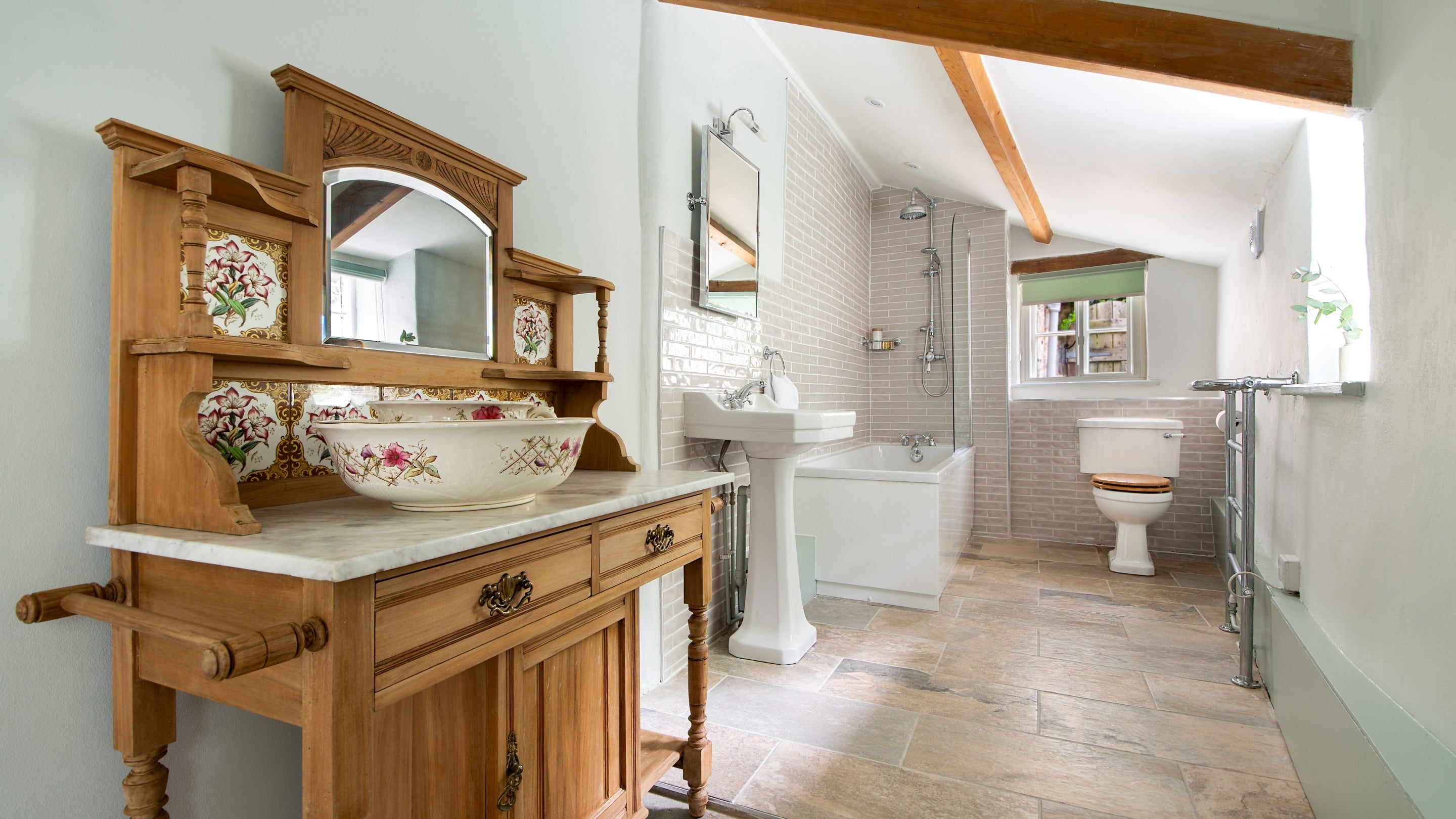 The bathroom, with shower over bath, on the ground floor of Boar Mill Cottage, Dorset