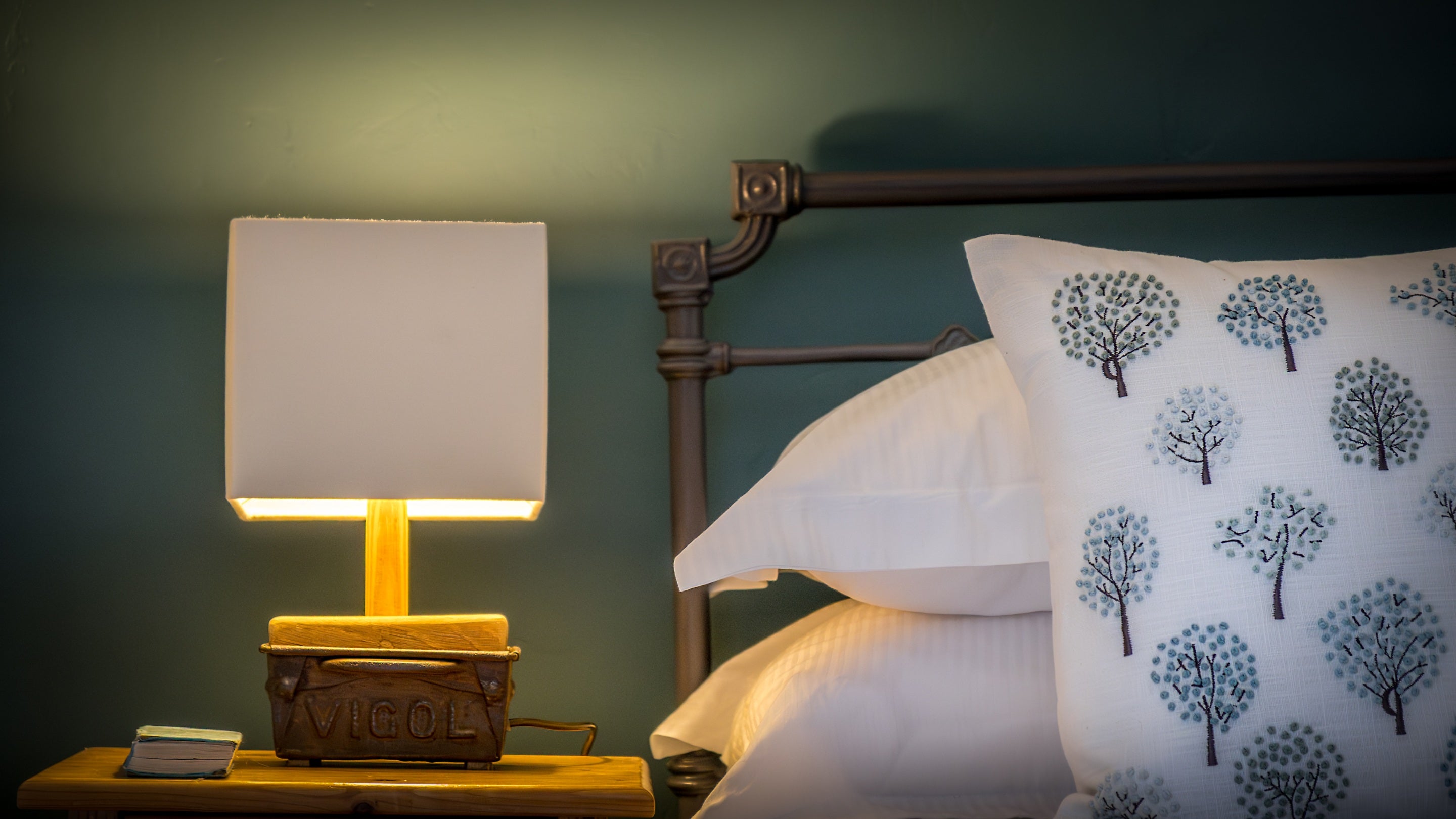 The bed and nightstand in the second double bedroom at Boar Mill Cottage, Dorset