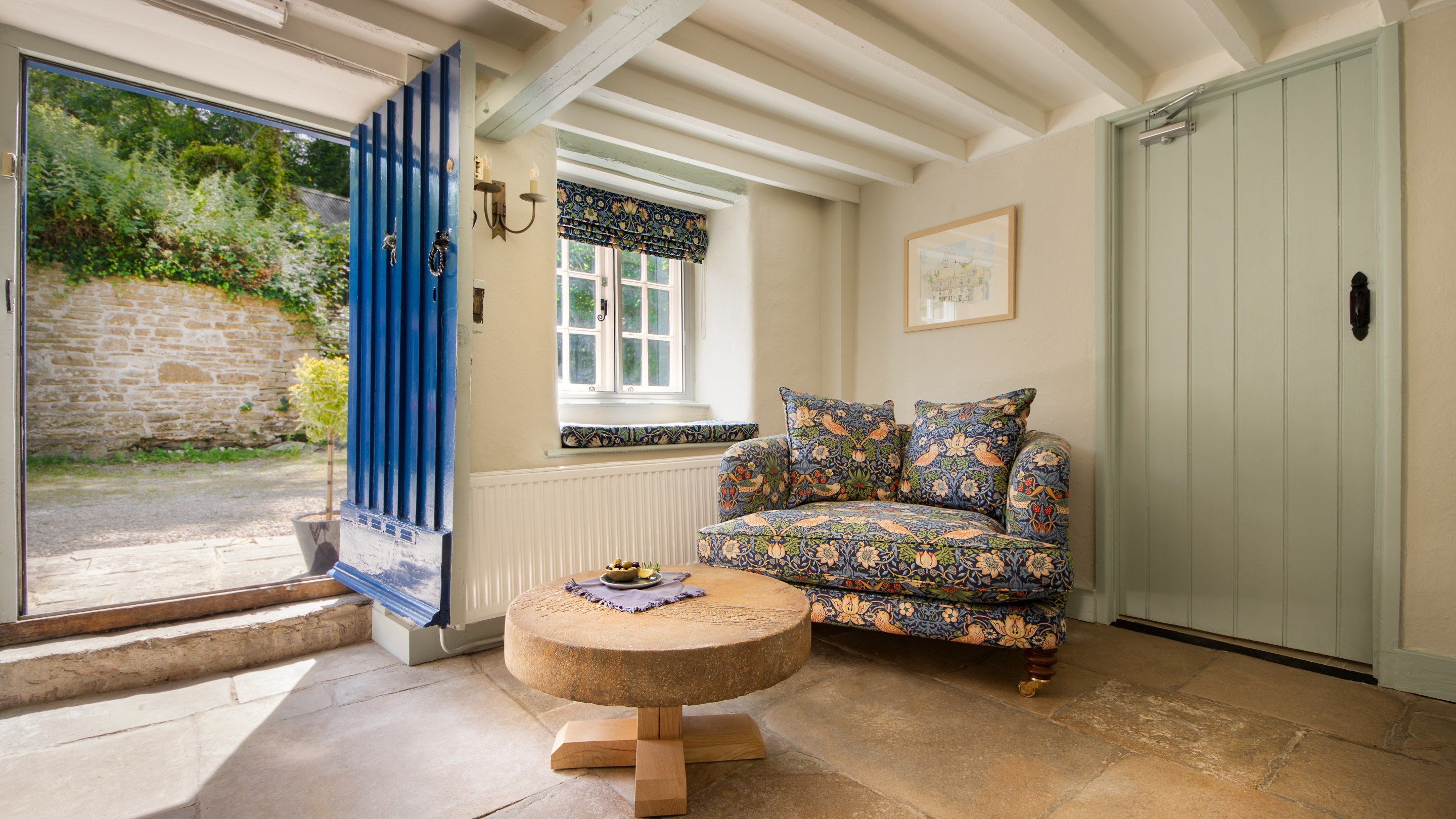 A corner of the dining room and the front door of Boar Mill Cottage, Dorset