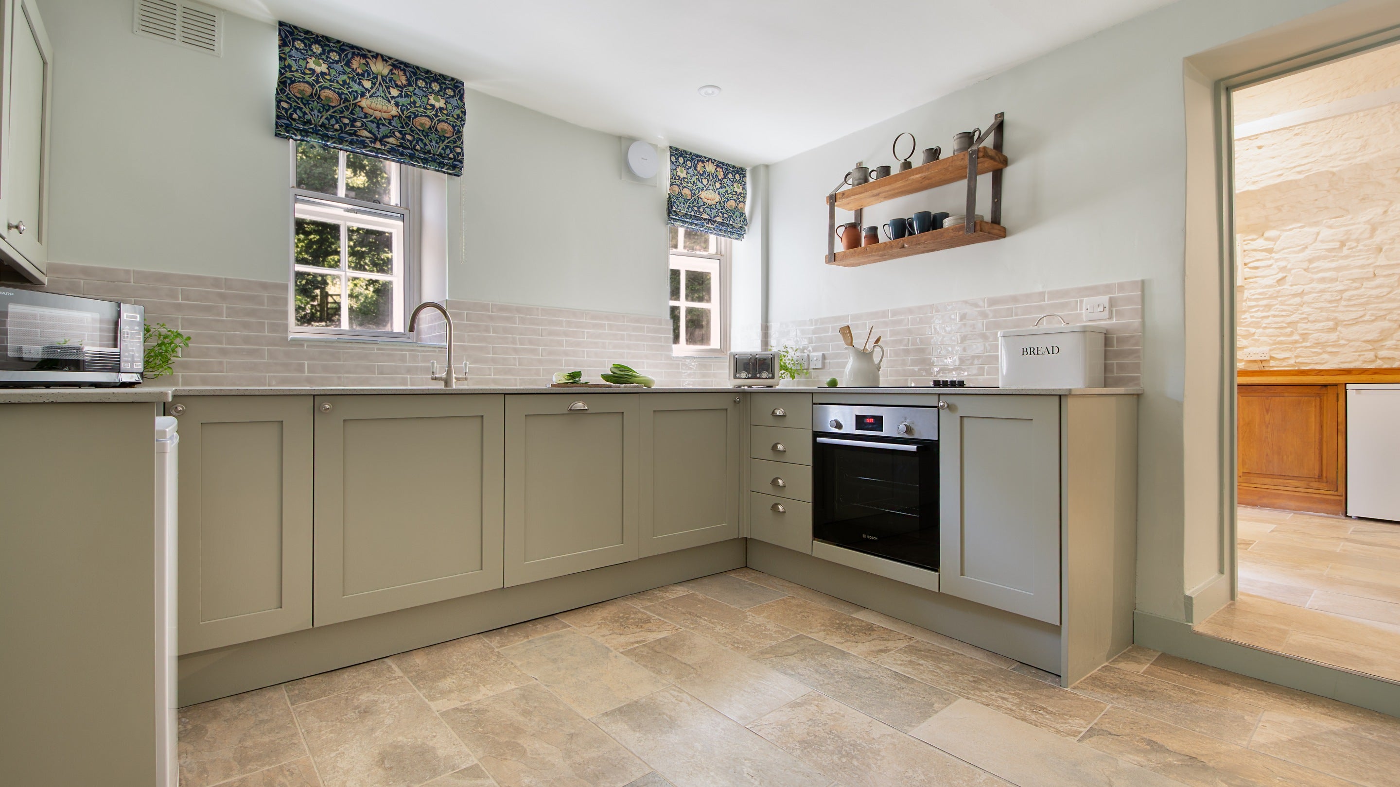 The kitchen at Boar Mill Cottage, with entrance to the utility room on the right, Dorset