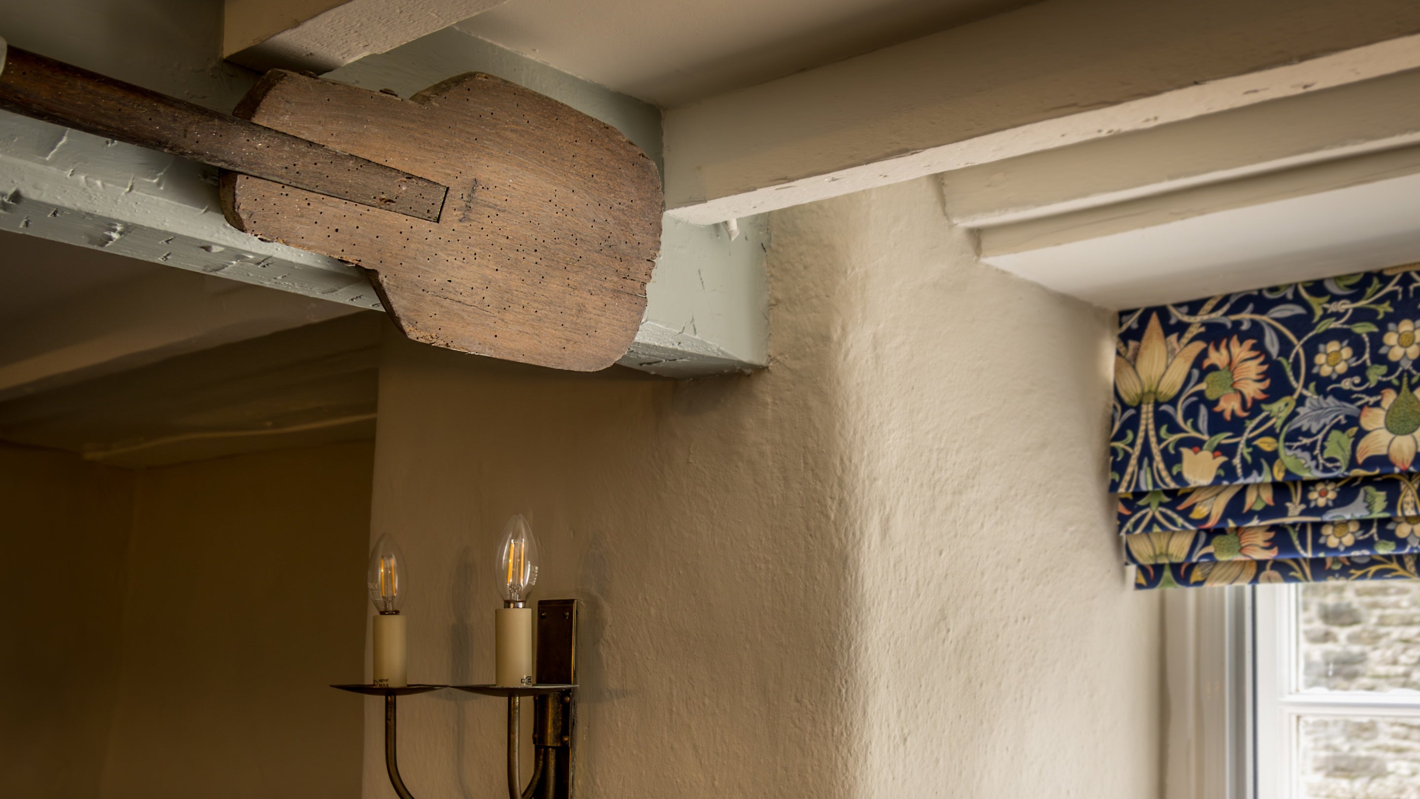 An original baker's paddle, hung on the ceiling in the dining room at Boar Mill Cottage, Dorset