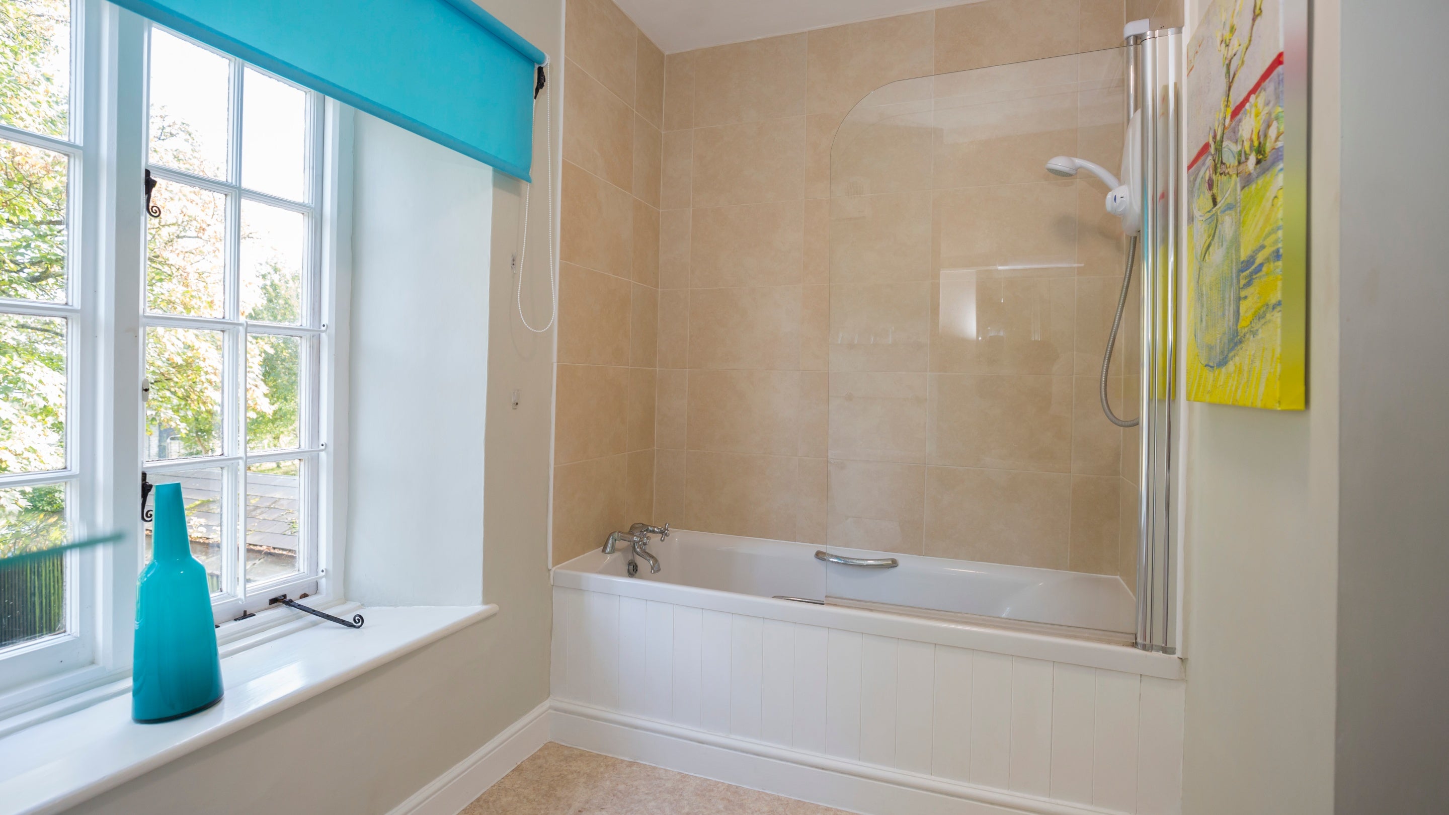 The bathroom with shower over bath at Downhouse Farm Cottage, Dorset