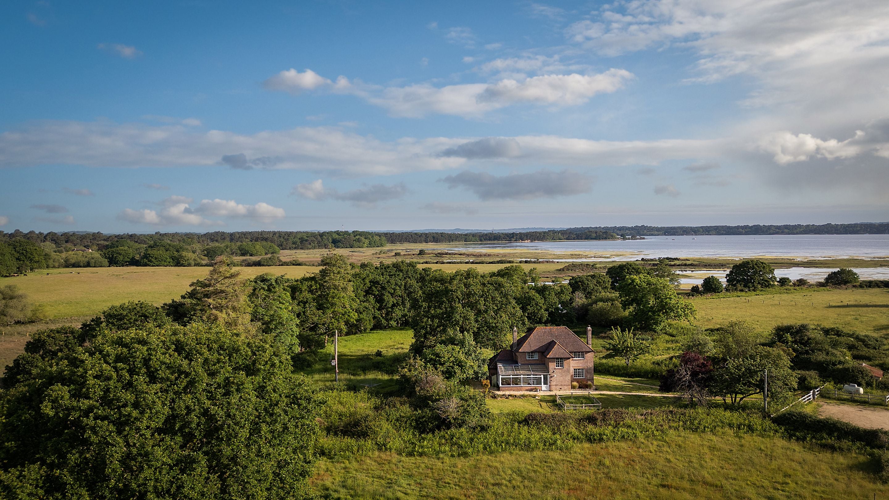 An aerial view of Greenlands, with Poole Harbour in the distance, Dorset