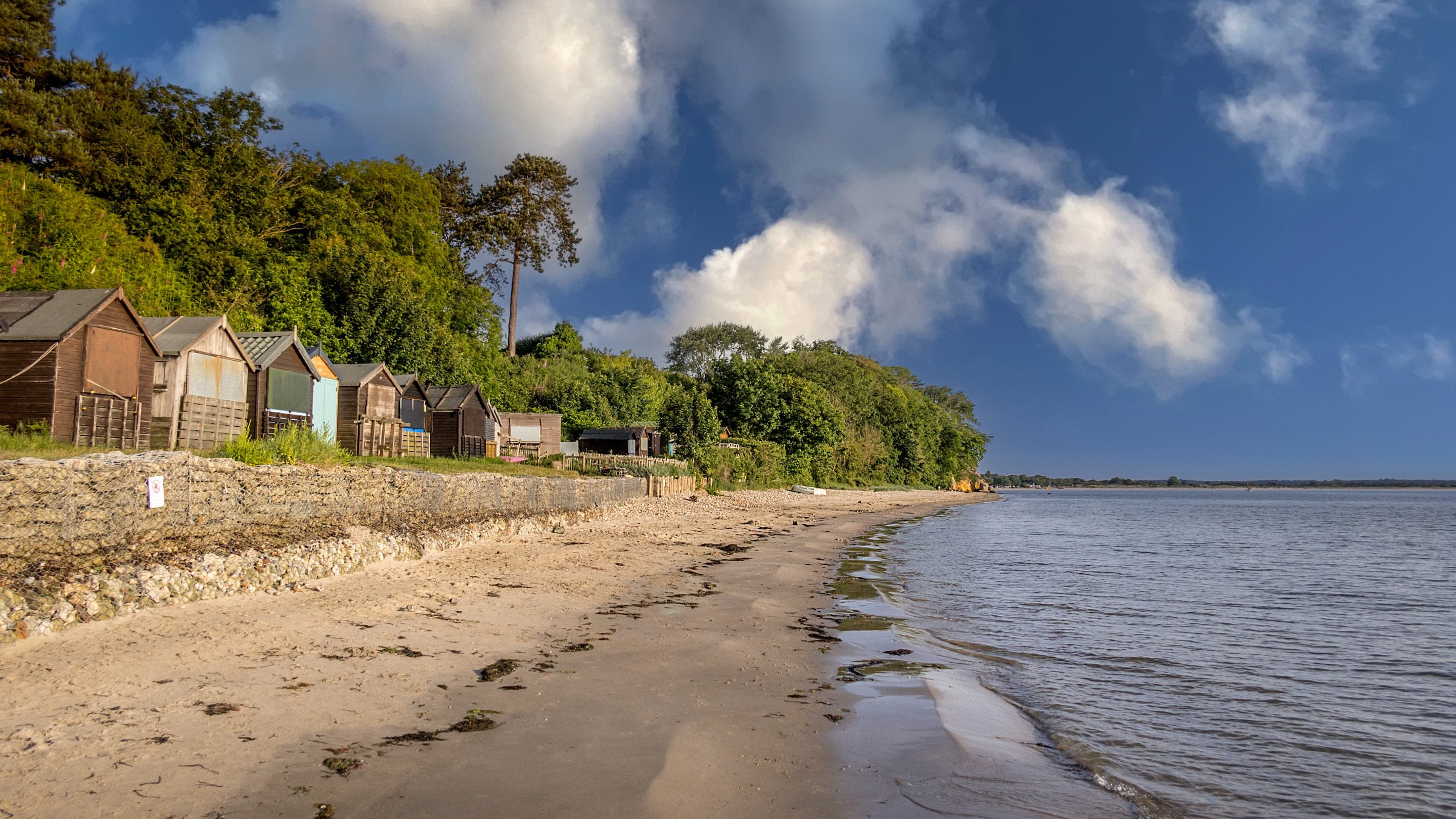 The sand beach with beach huts at Studland Bay, five minutes drive from Greenlands, Dorset
