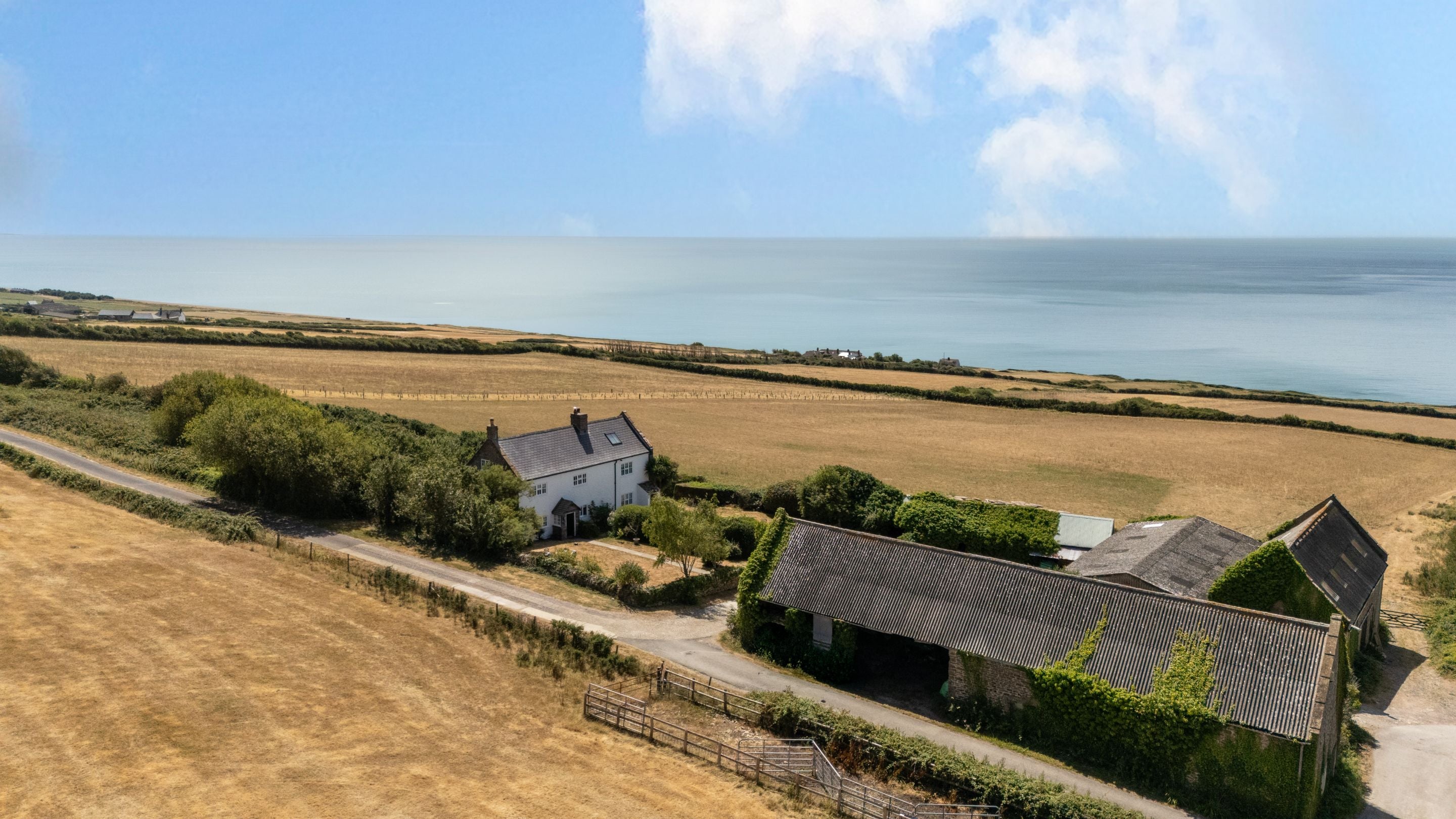 An aerial view of Labour in Vain Cottage, Chesil Cottage and the neighbouring farm buildings, Dorset