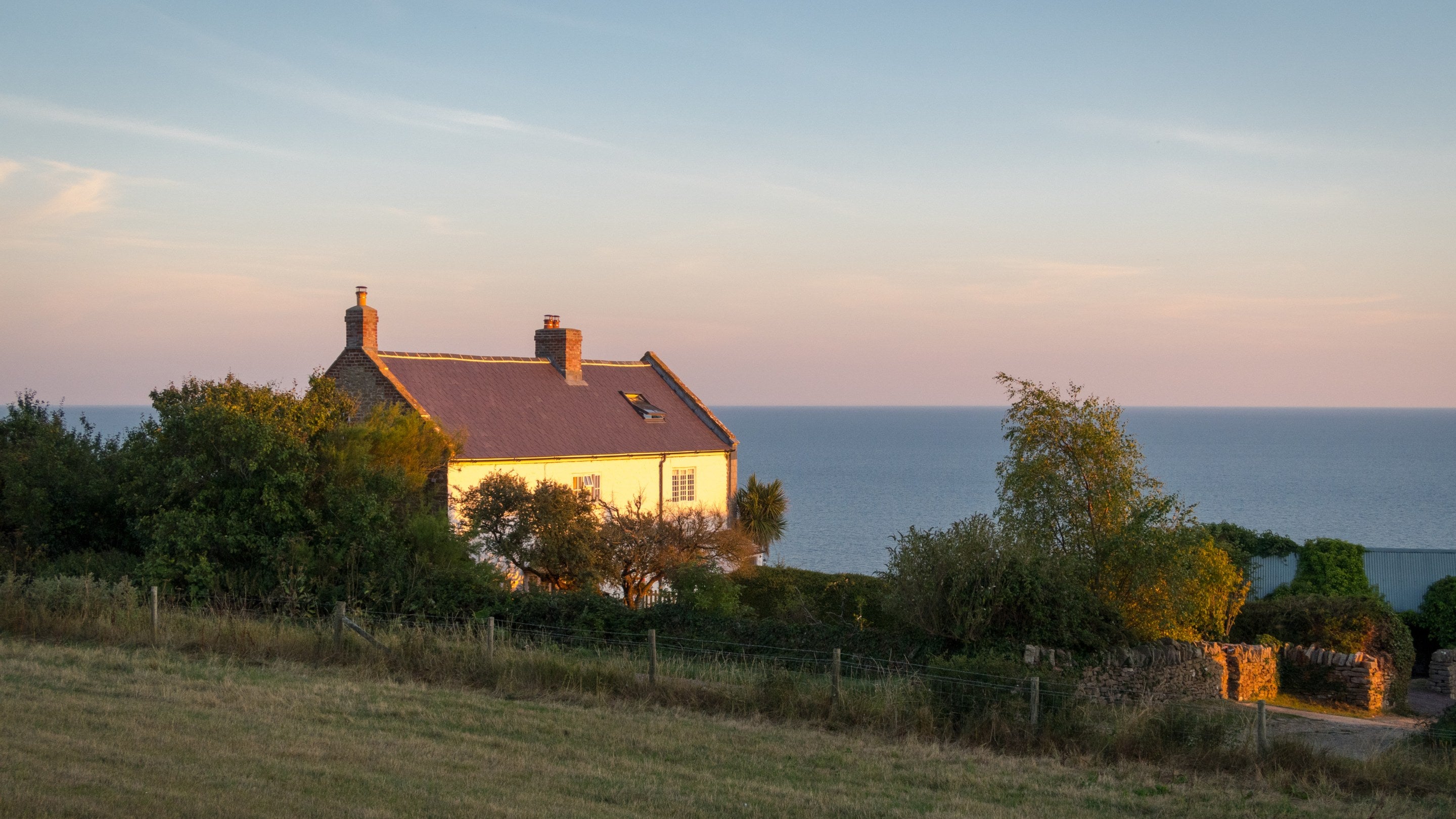Labour in Vain Cottage (on the left) before refurbishment and Chesil Cottage (on the right) at sunset, Dorset