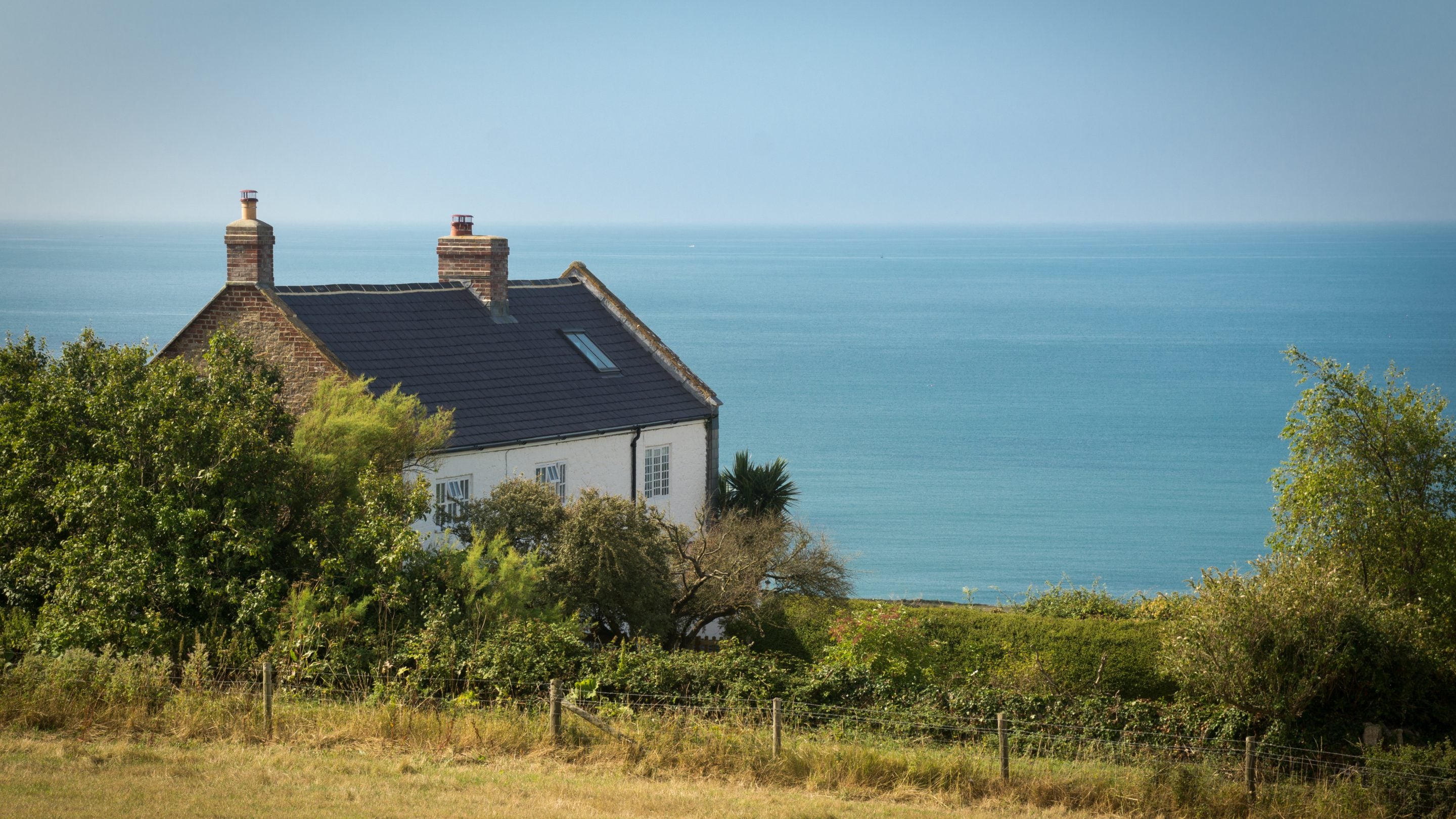 Labour in Vain Cottage (on the left) before refurbishment and Chesil Cottage (on the right) overlooking the sea, Dorset